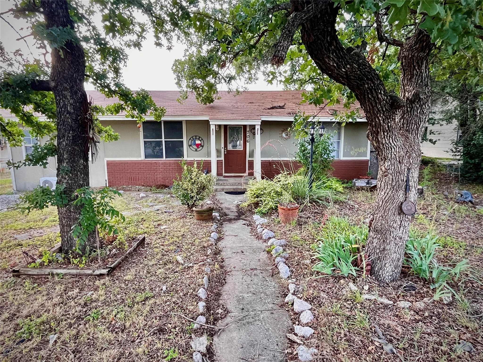 Well-positioned commercial property with strong visibility along Early Boulevard and a welcoming entrance beneath mature shade trees.