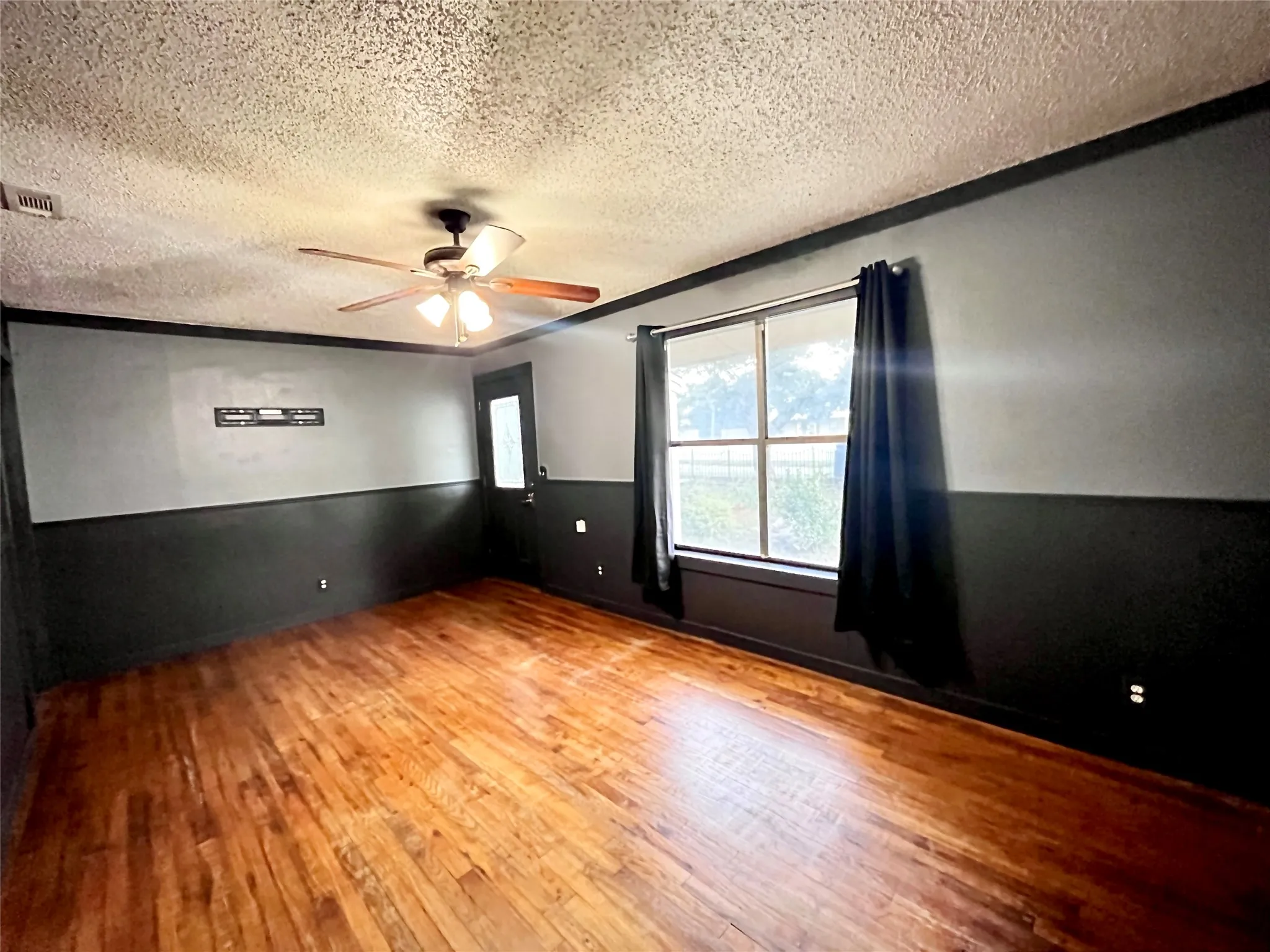 Bright front office with prominent street-facing windows, making an ideal reception area, executive office, or client meeting space.