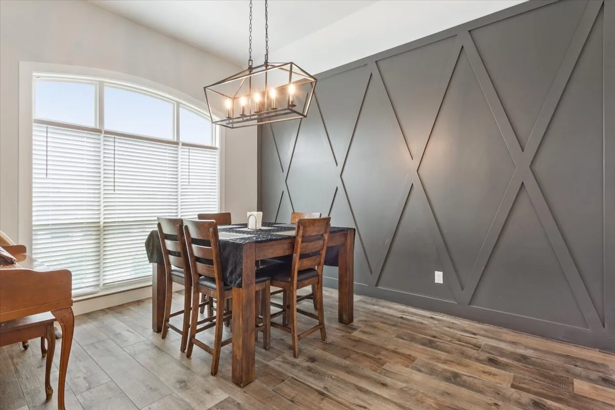 Dining area featuring a prominent accent wall with geometric paneling