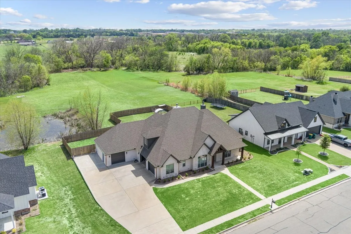 Contemporary residence with a multi-gabled roofline, light-colored exterior, and an attached two-car garage