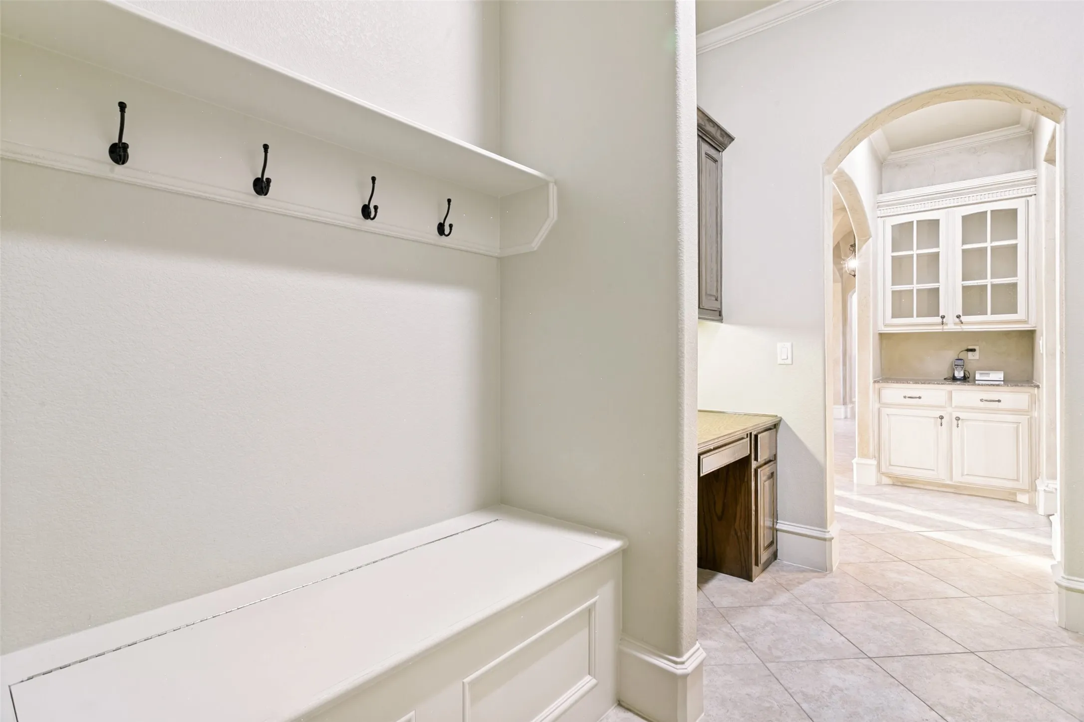 Garage entry.  Mud room with built in drop zone.  Built in desk.  Butlers Pantry