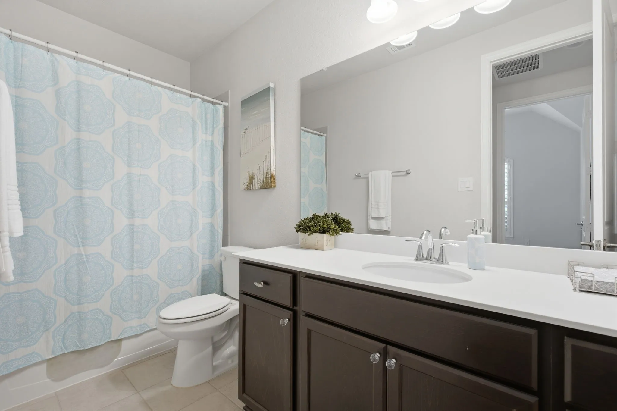 One of 3 full bathrooms, this one is located across from the guest bedroom