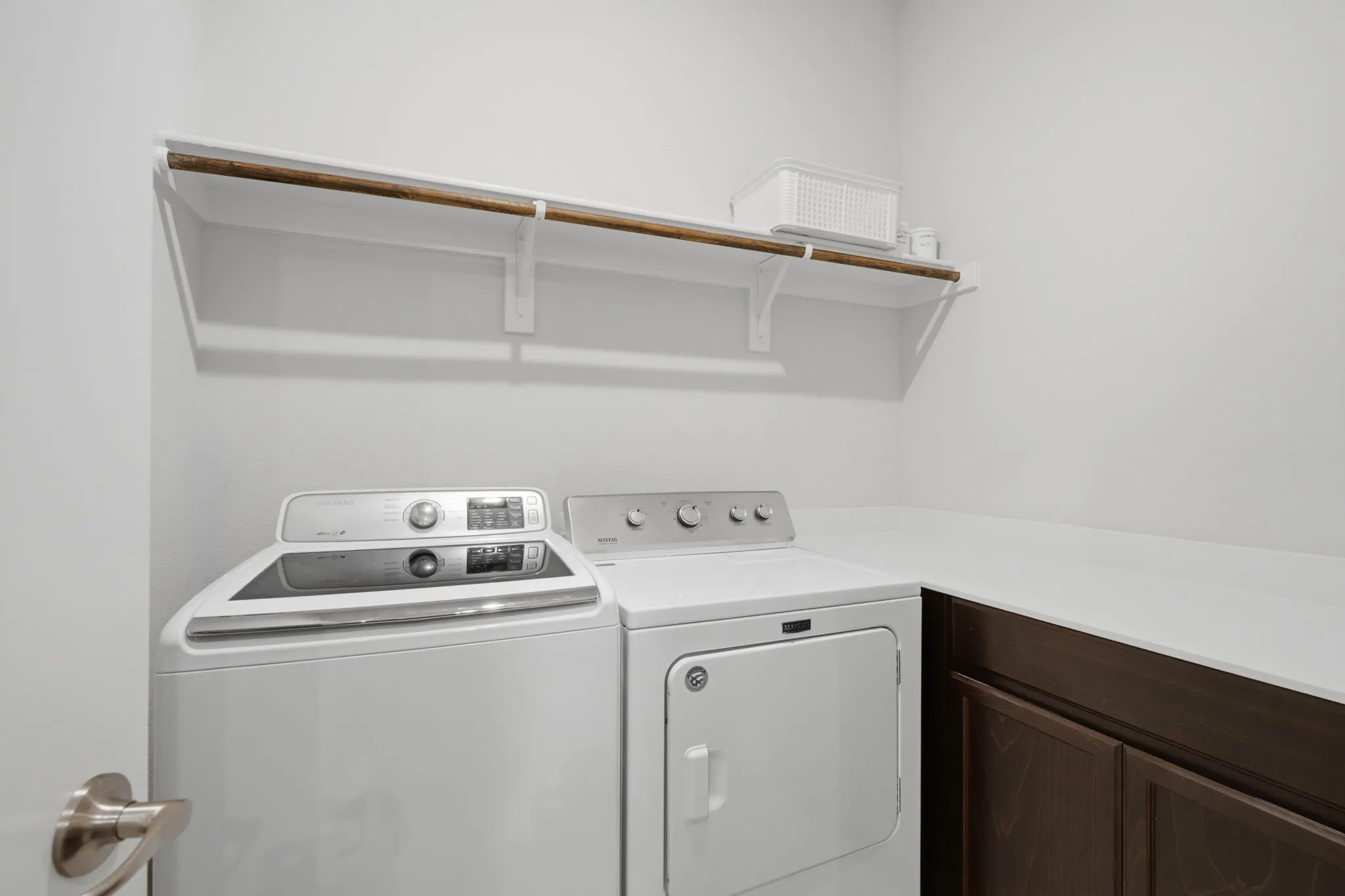 Full Size Utility room with counter space for folding, cabinetry, and shelving.