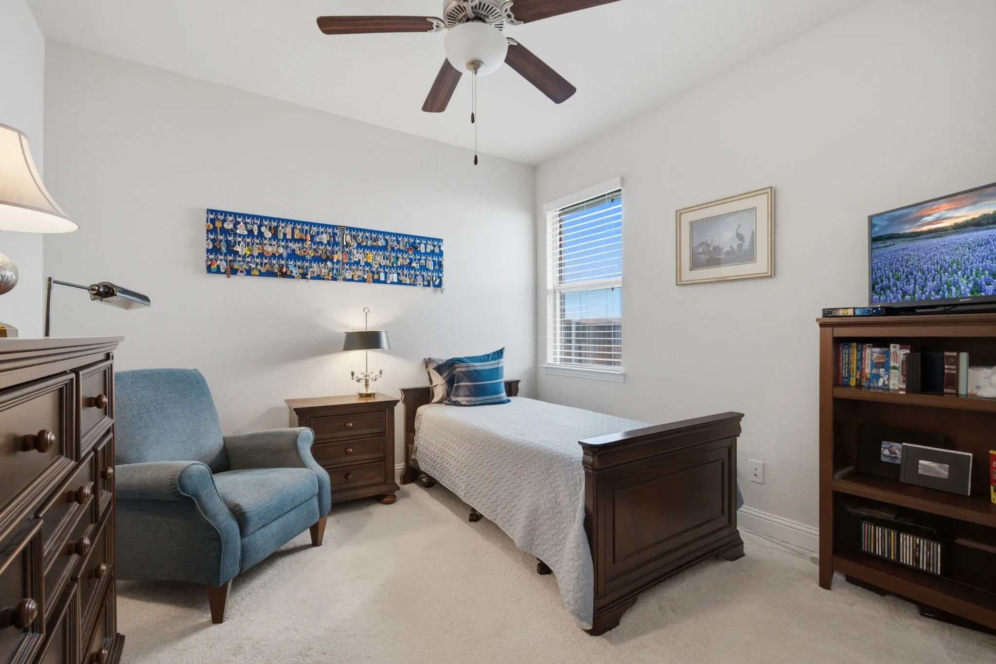 One of 3 bedrooms with ceiling fan and walk in closet.