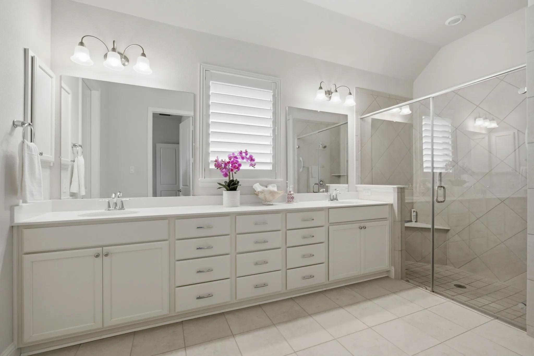 Spacious Walk in oversized shower, dual sinks and ample counterspace and storage for this Primary Bedroom