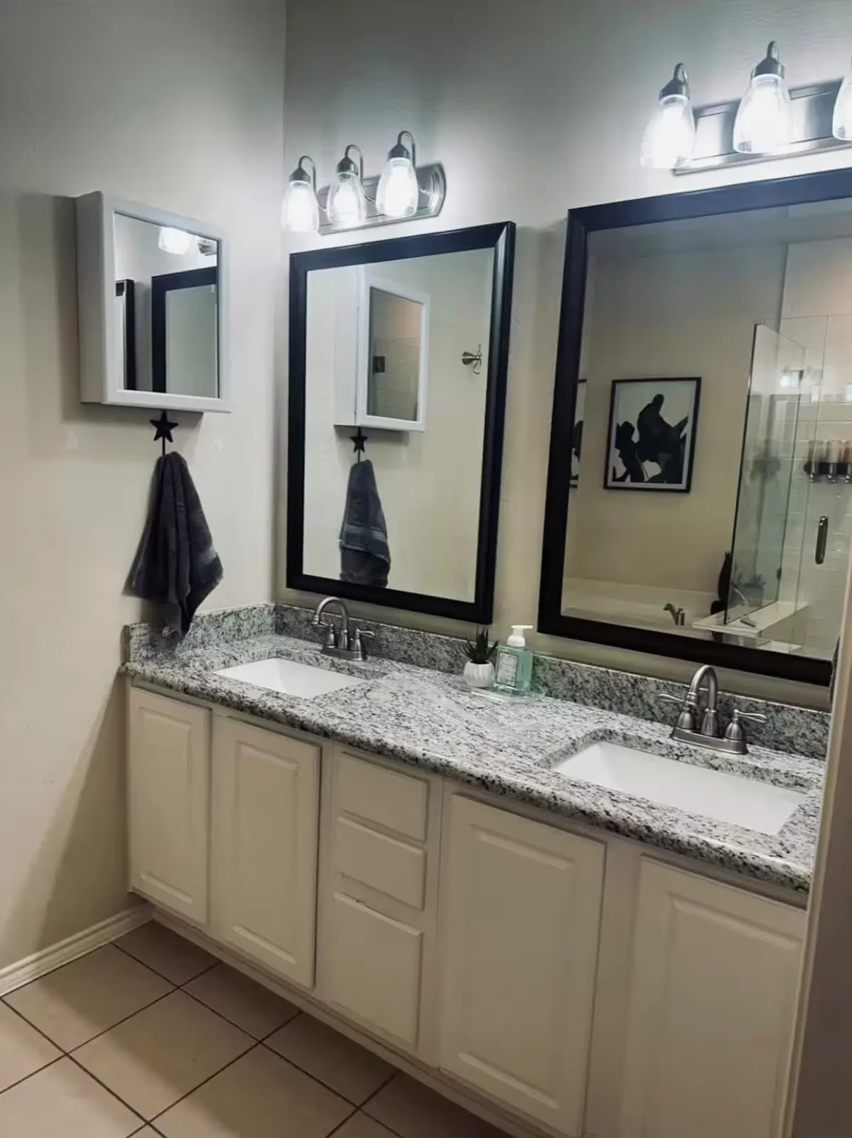 Dual vanity with light granite-look countertops and integrated white sinks