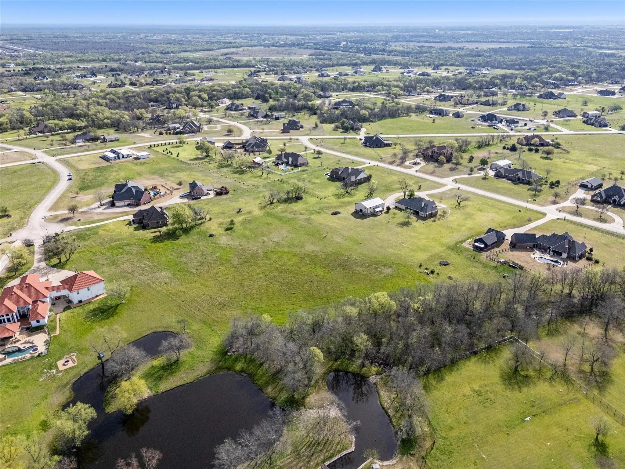 Expansive rural landscape featuring multiple properties on large parcels