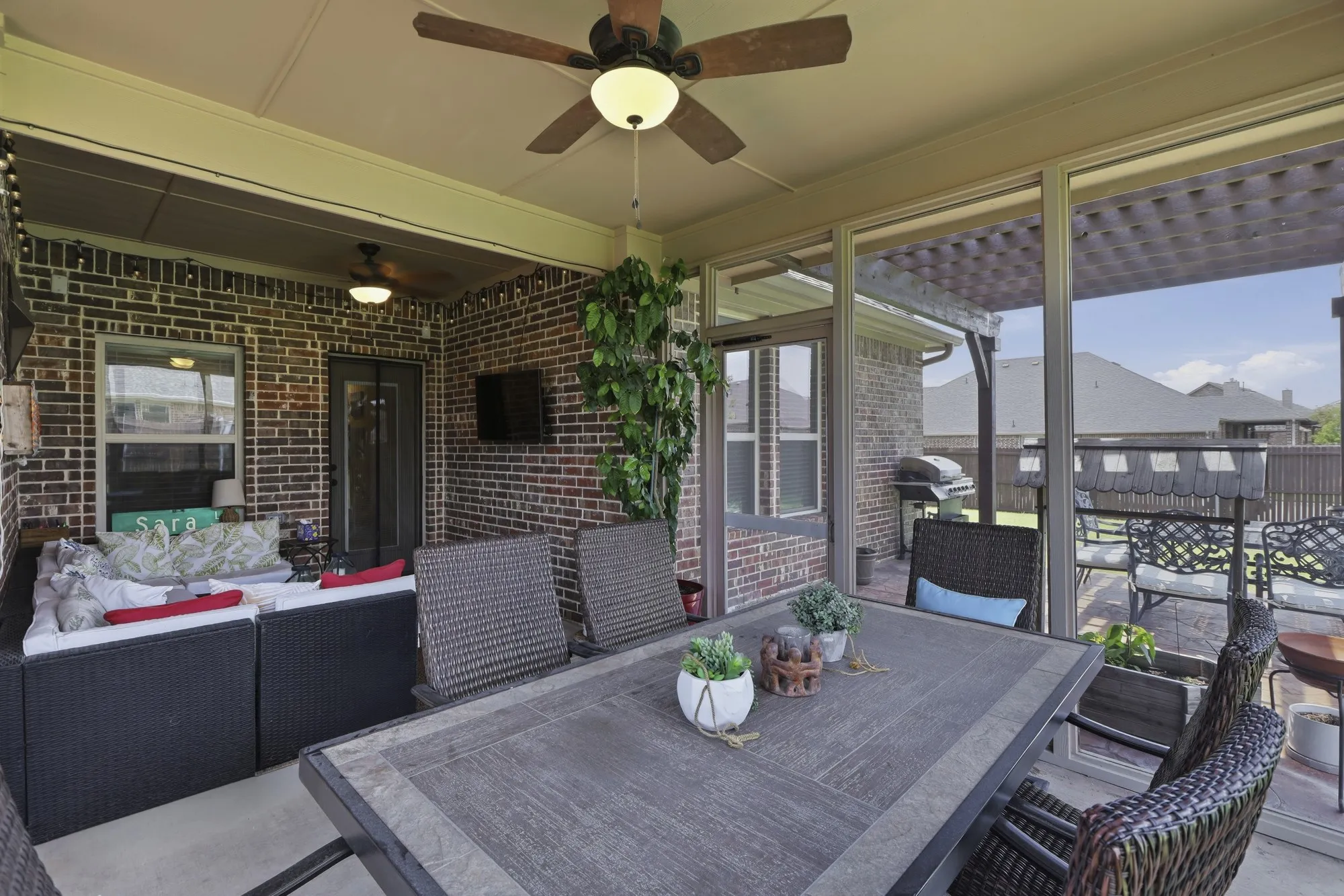 Another view of screene-in sunroom with dining and TV areas!