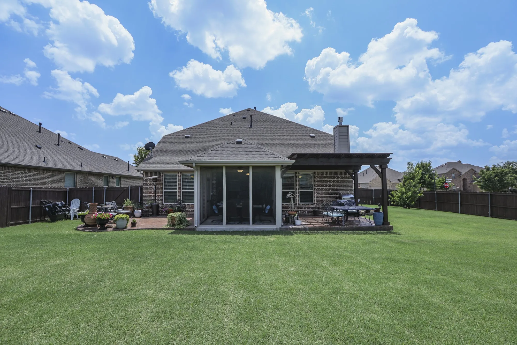 Oversized backyard, sunroom and bonus patio areas, one with pergula!