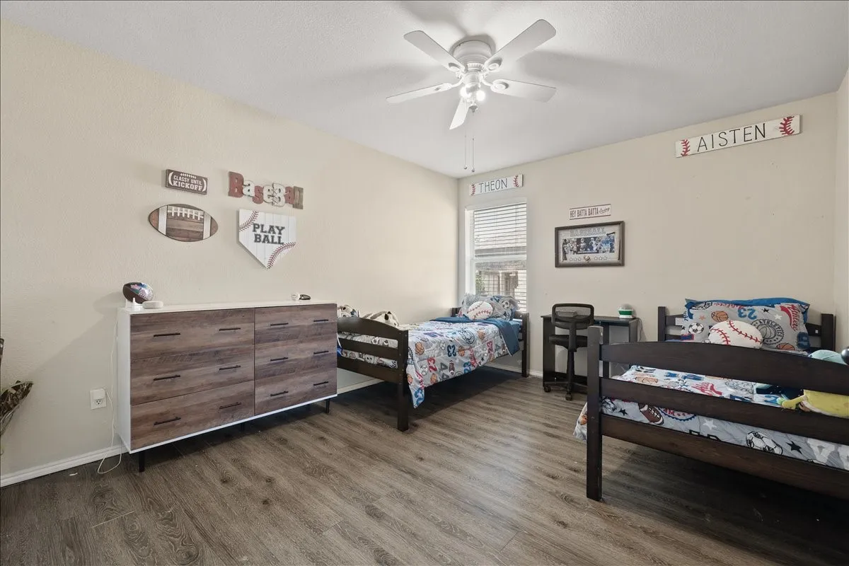 Bright room featuring wood-finish flooring and neutral wall tones