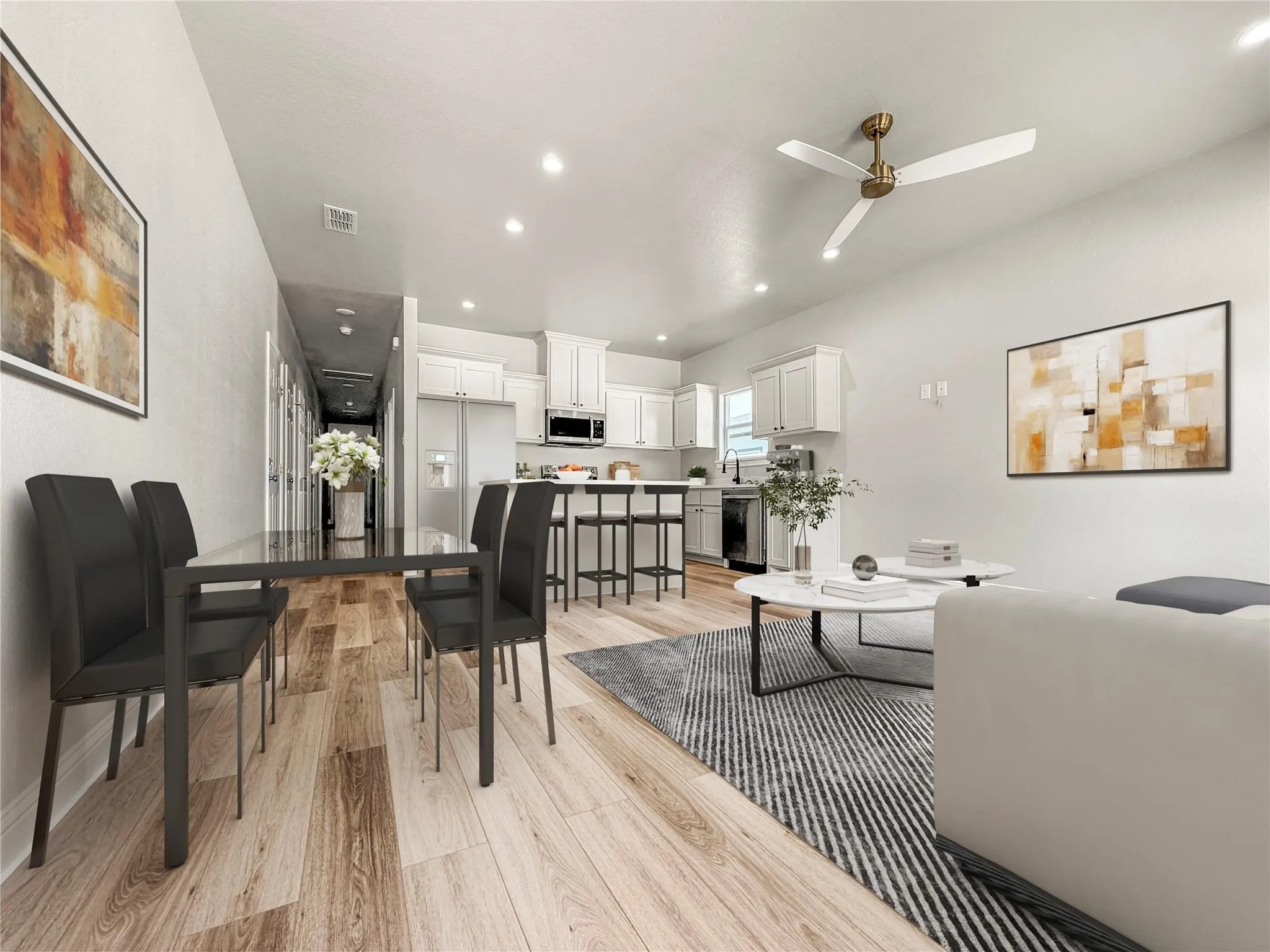 Room with neutral gray walls, plush gray carpet, a white ceiling fan with integrated lighting, and two windows providing natural light