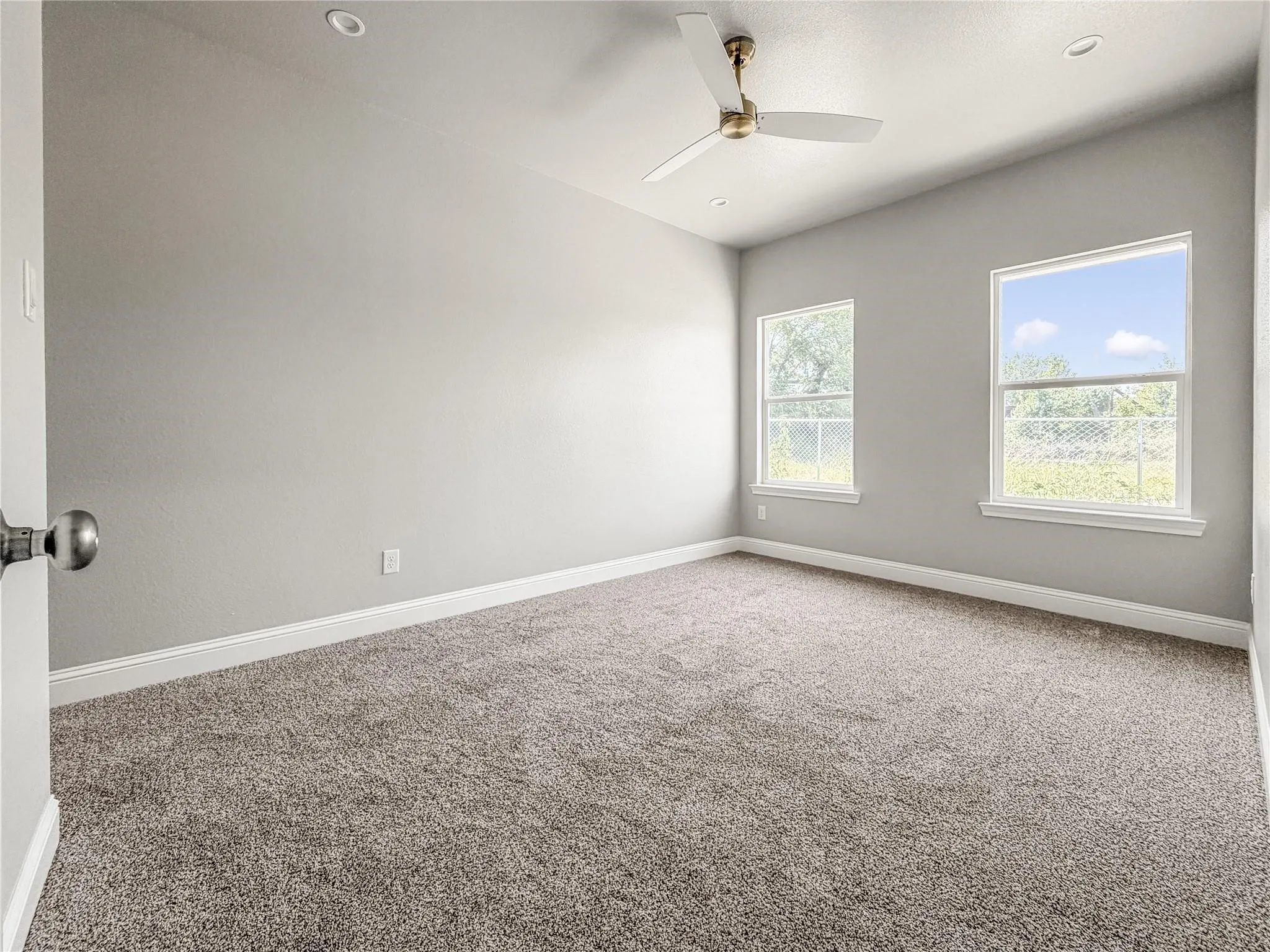 Open-concept living space featuring wood-finish flooring, recessed lighting, and a contemporary ceiling fan