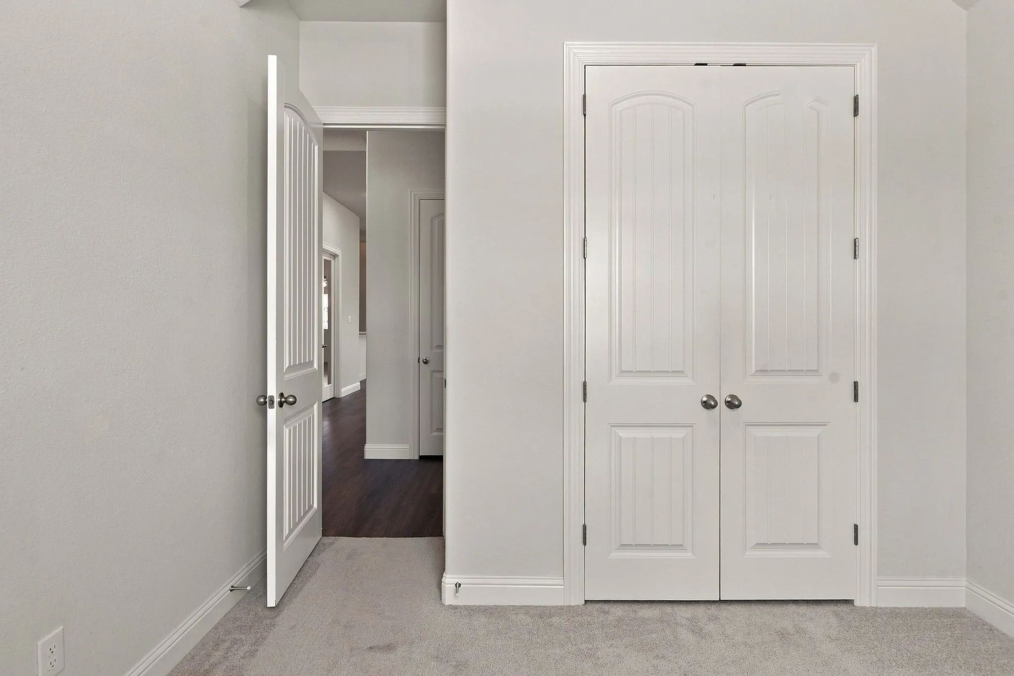 White bi-fold closet doors with panel detailing