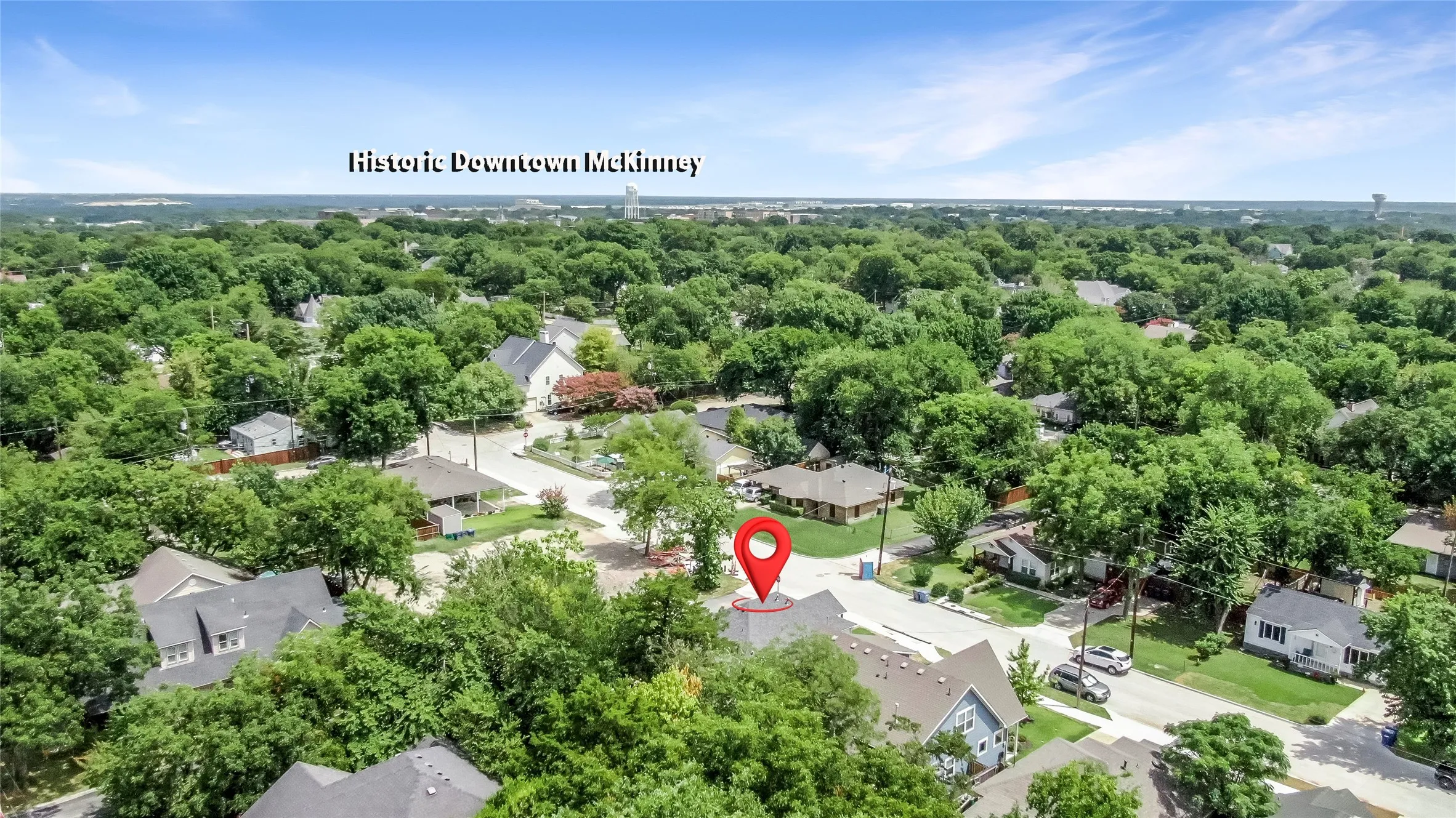 Aerial perspective showcasing a residential neighborhood with abundant mature trees