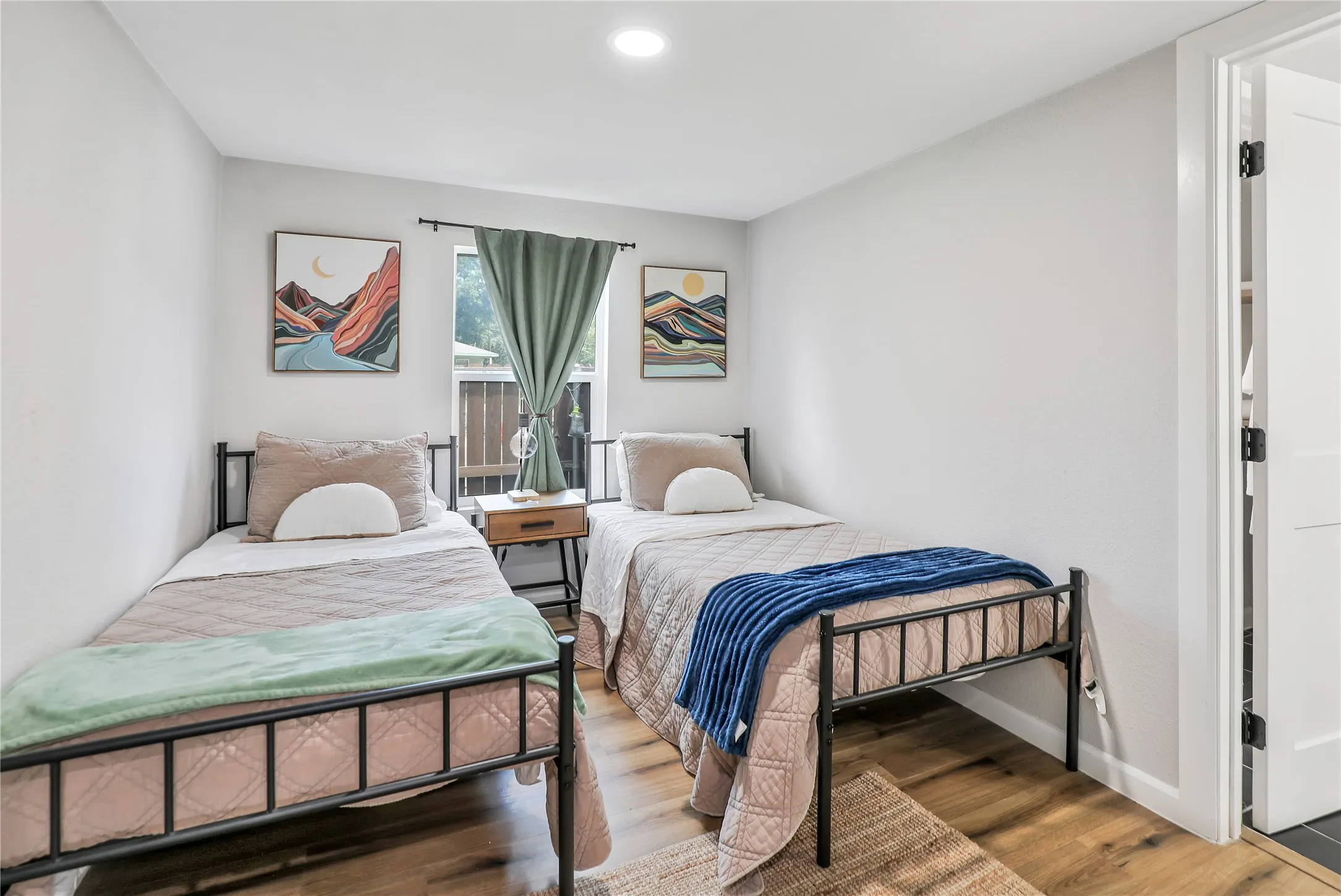Room featuring wood-finish flooring, light grey walls, and a recessed ceiling light