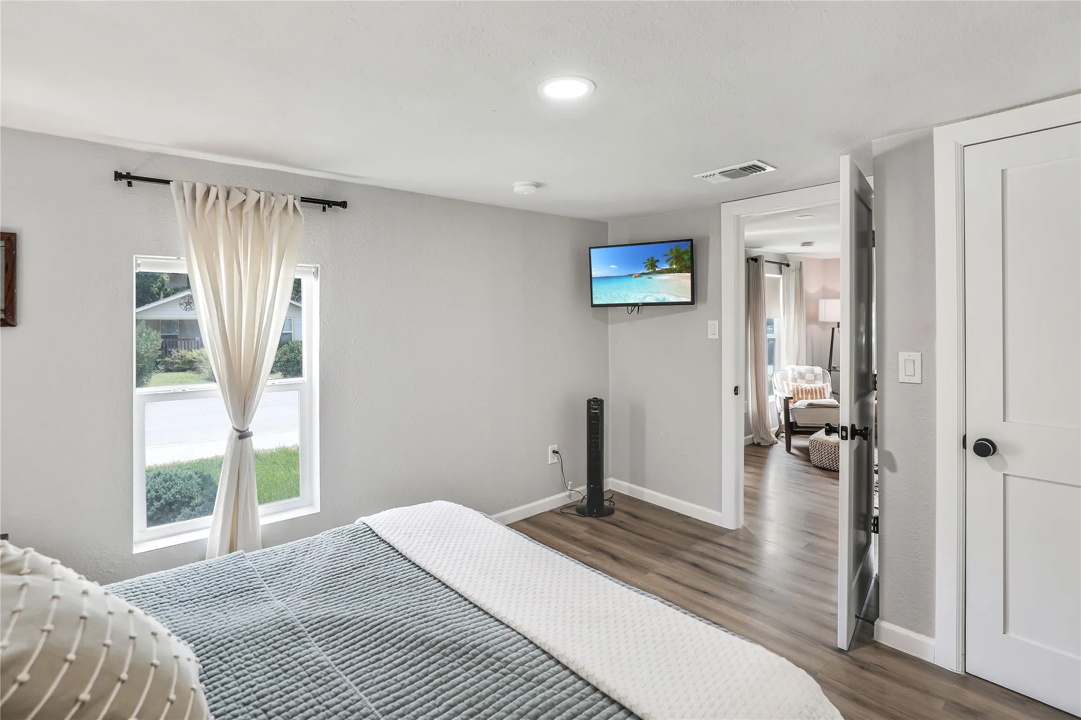 Interior space featuring wood-finish flooring, recessed lighting, and a window with white trim