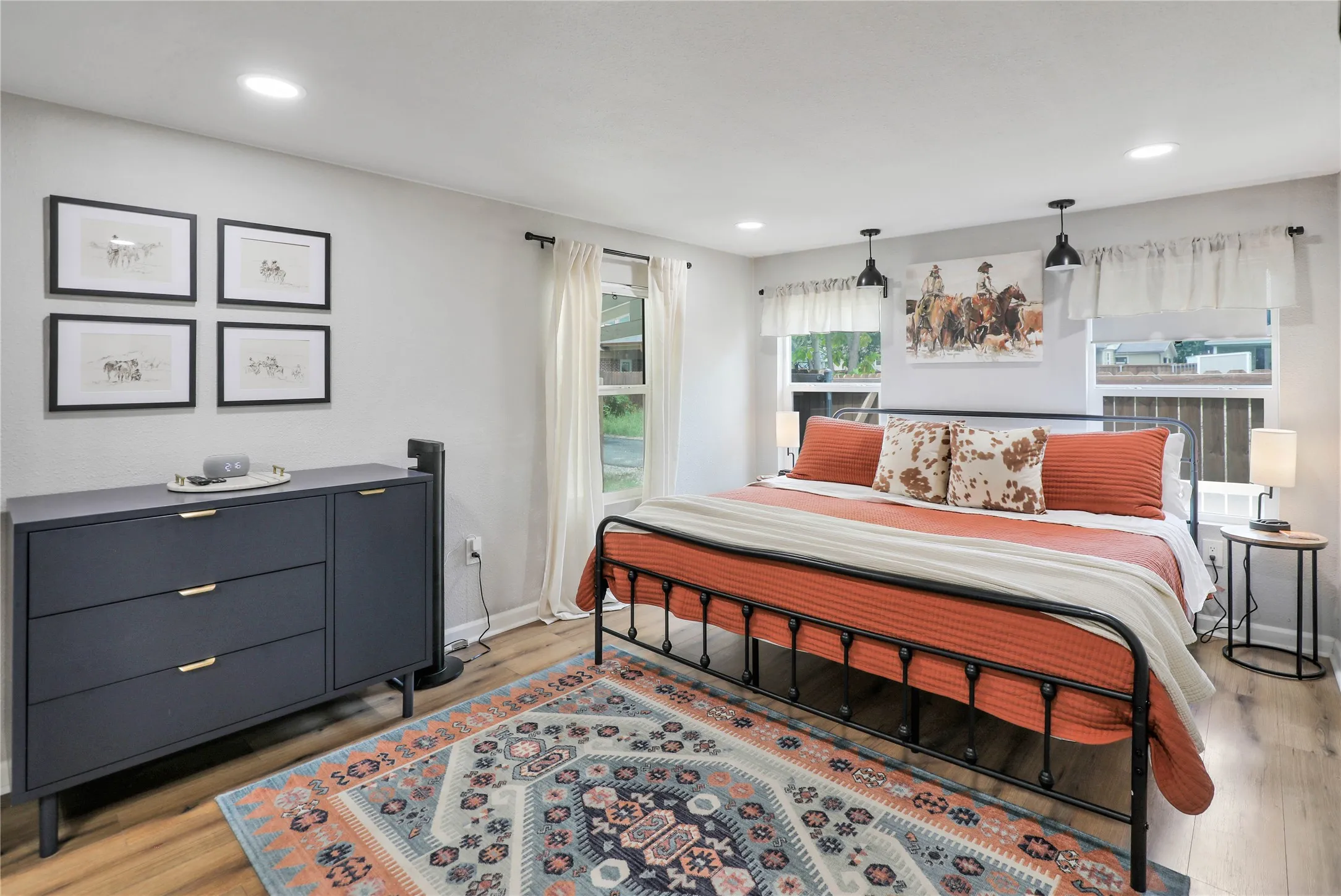 Spacious room featuring wood-finish flooring, recessed lighting, and multiple windows
