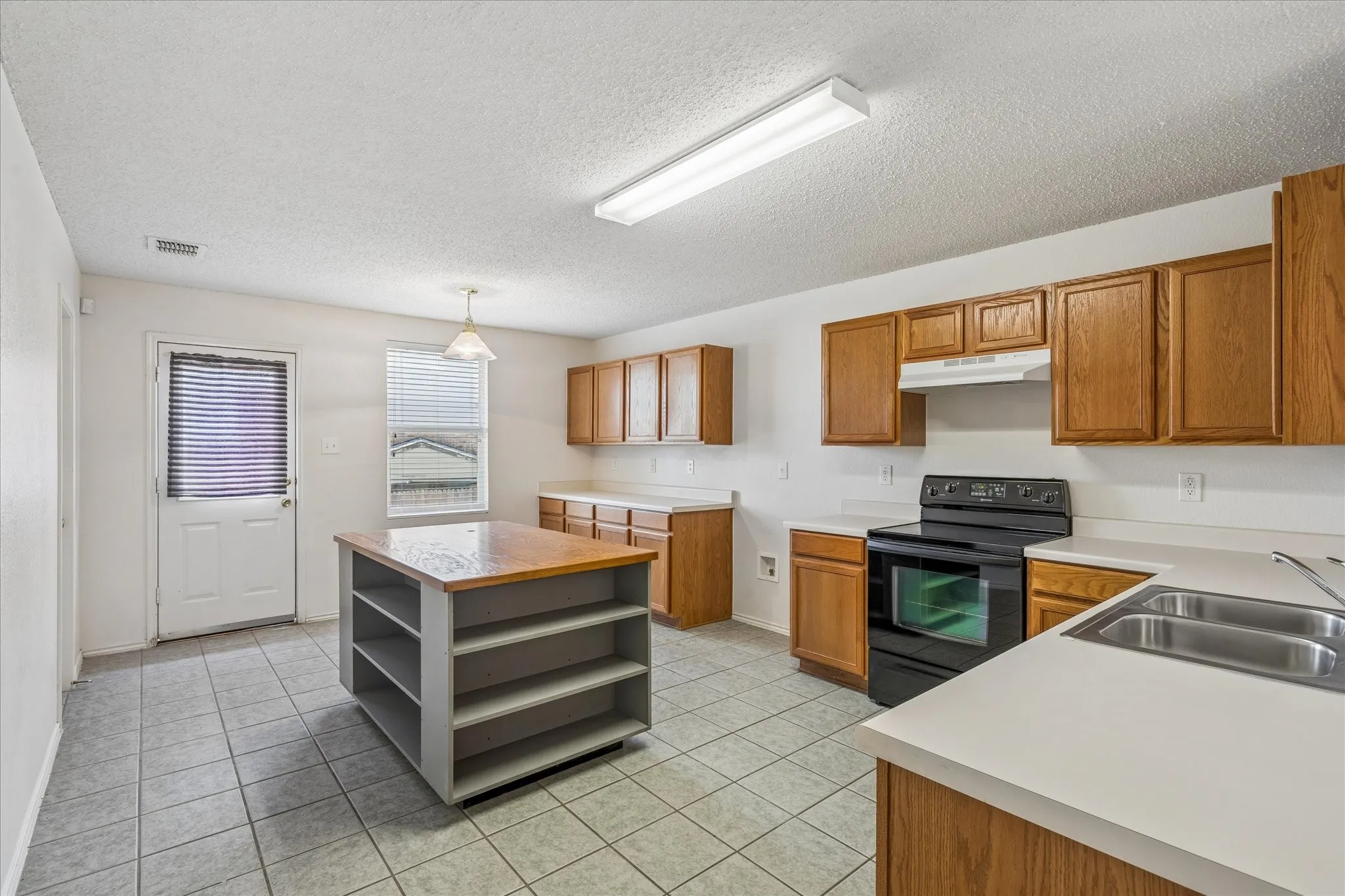 Kitchen has abundant cabinets and counter space.