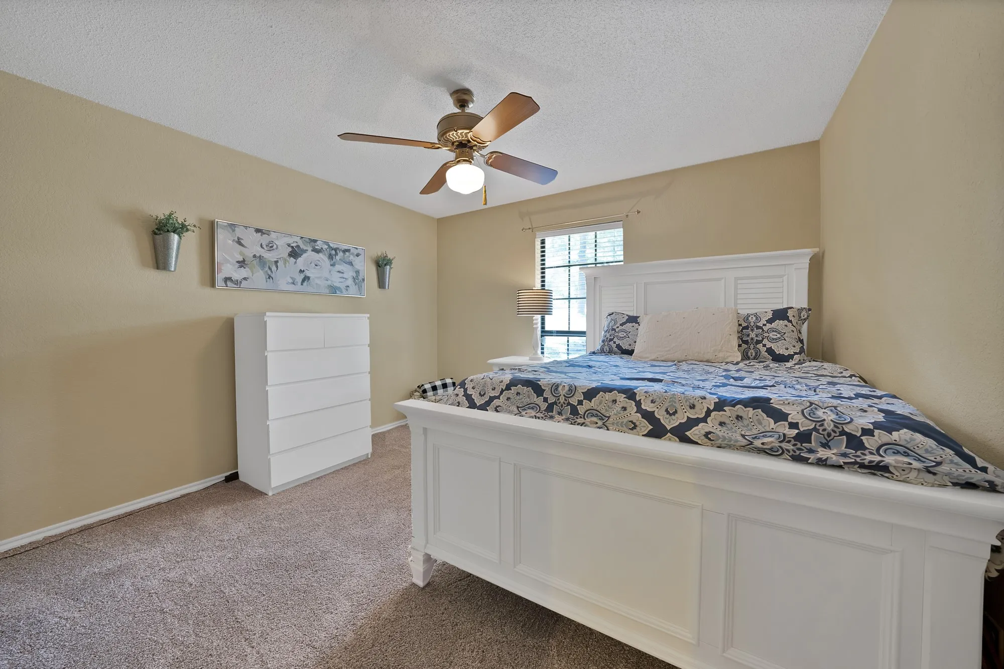 Carpeted flooring, ceiling fan with integrated lighting, window with blinds, and neutral wall tones