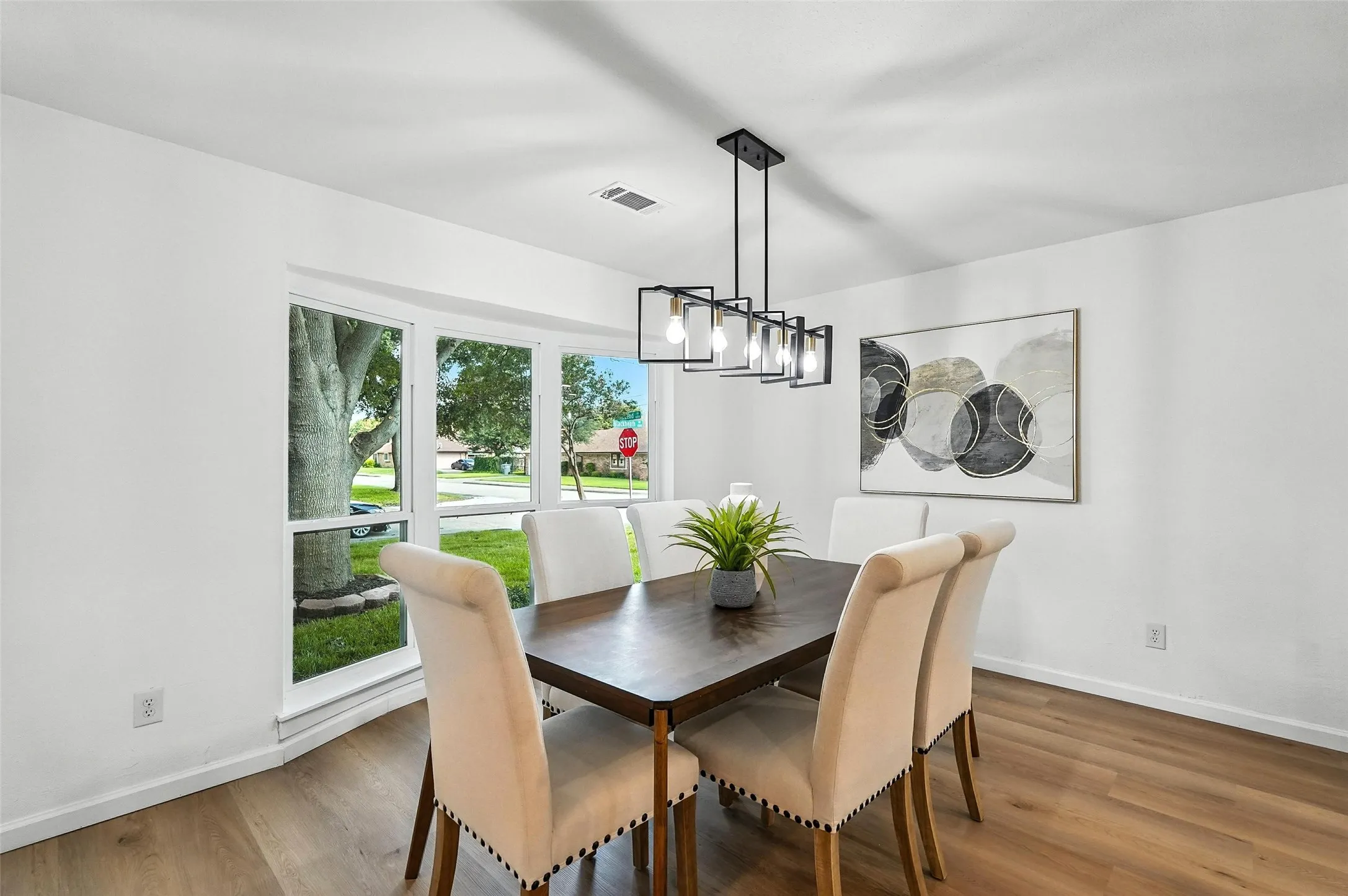 Dining room with wood finished floors and a chandelier