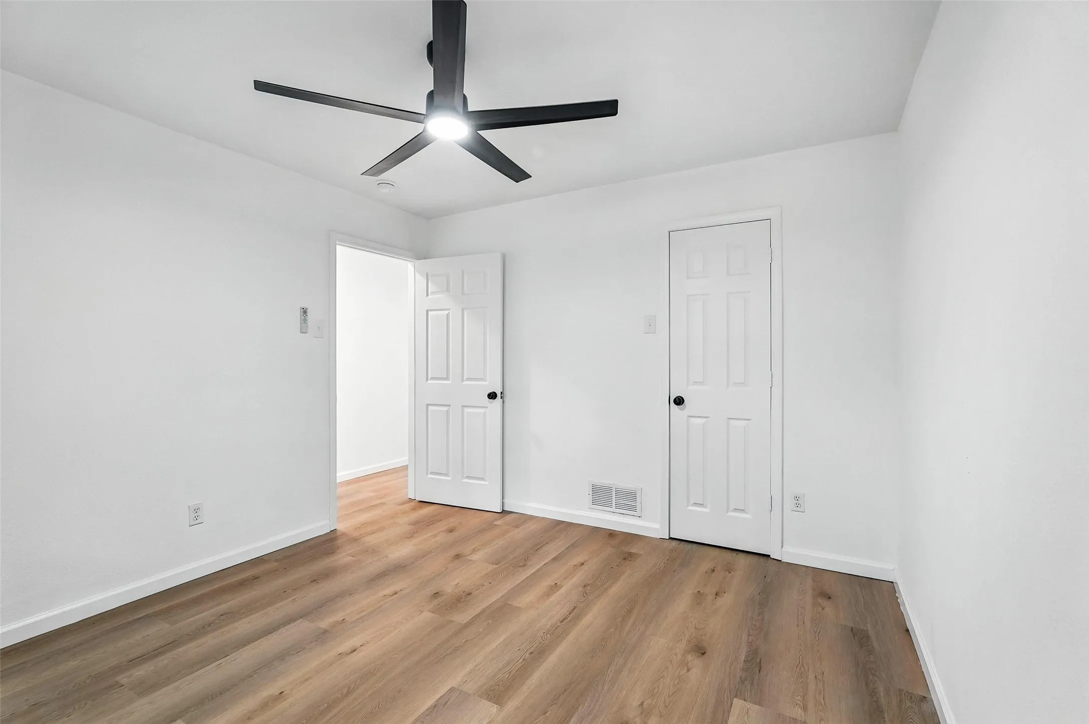 Unfurnished bedroom with light wood-style flooring and a ceiling fan