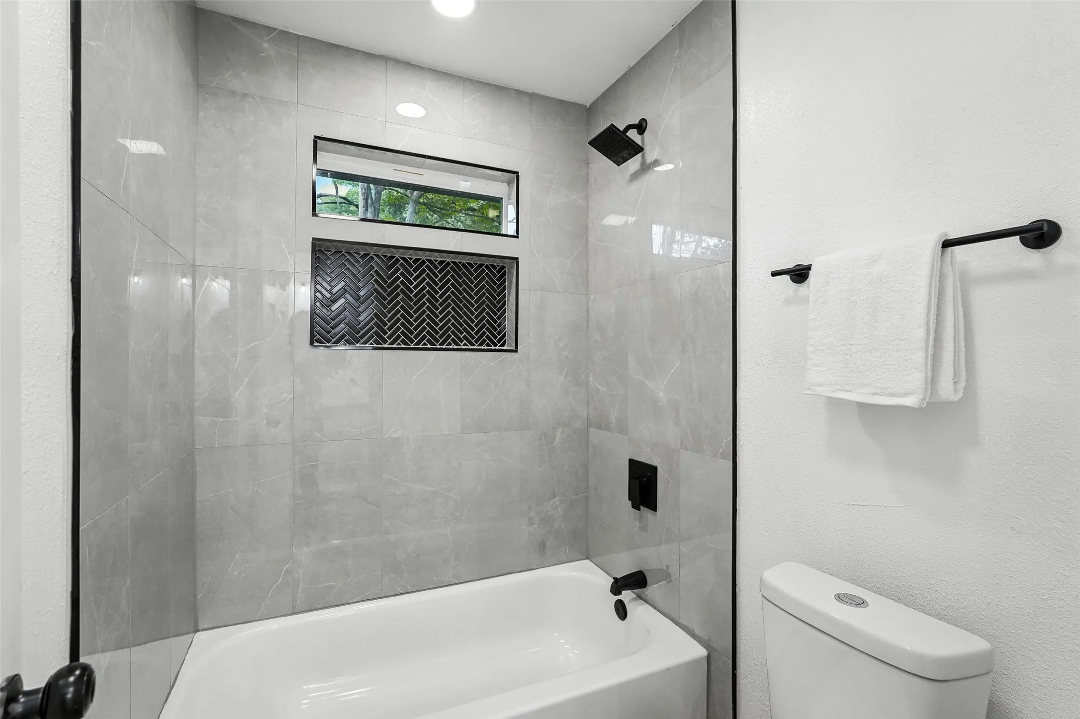 Full bathroom featuring toilet and shower / bath combination