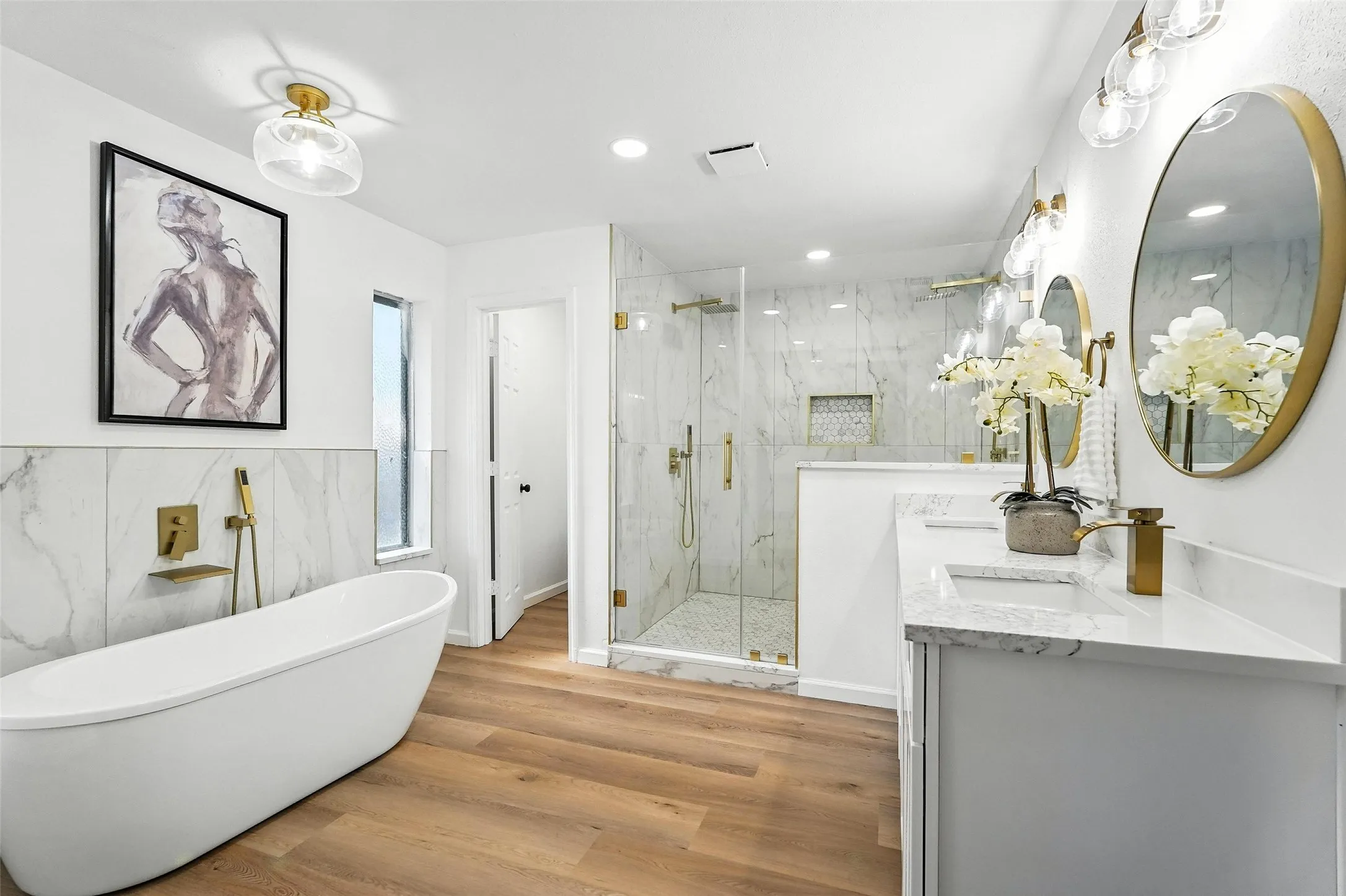 Bathroom with a marble finish shower, a soaking tub, wood finished floors, double vanity, and recessed lighting