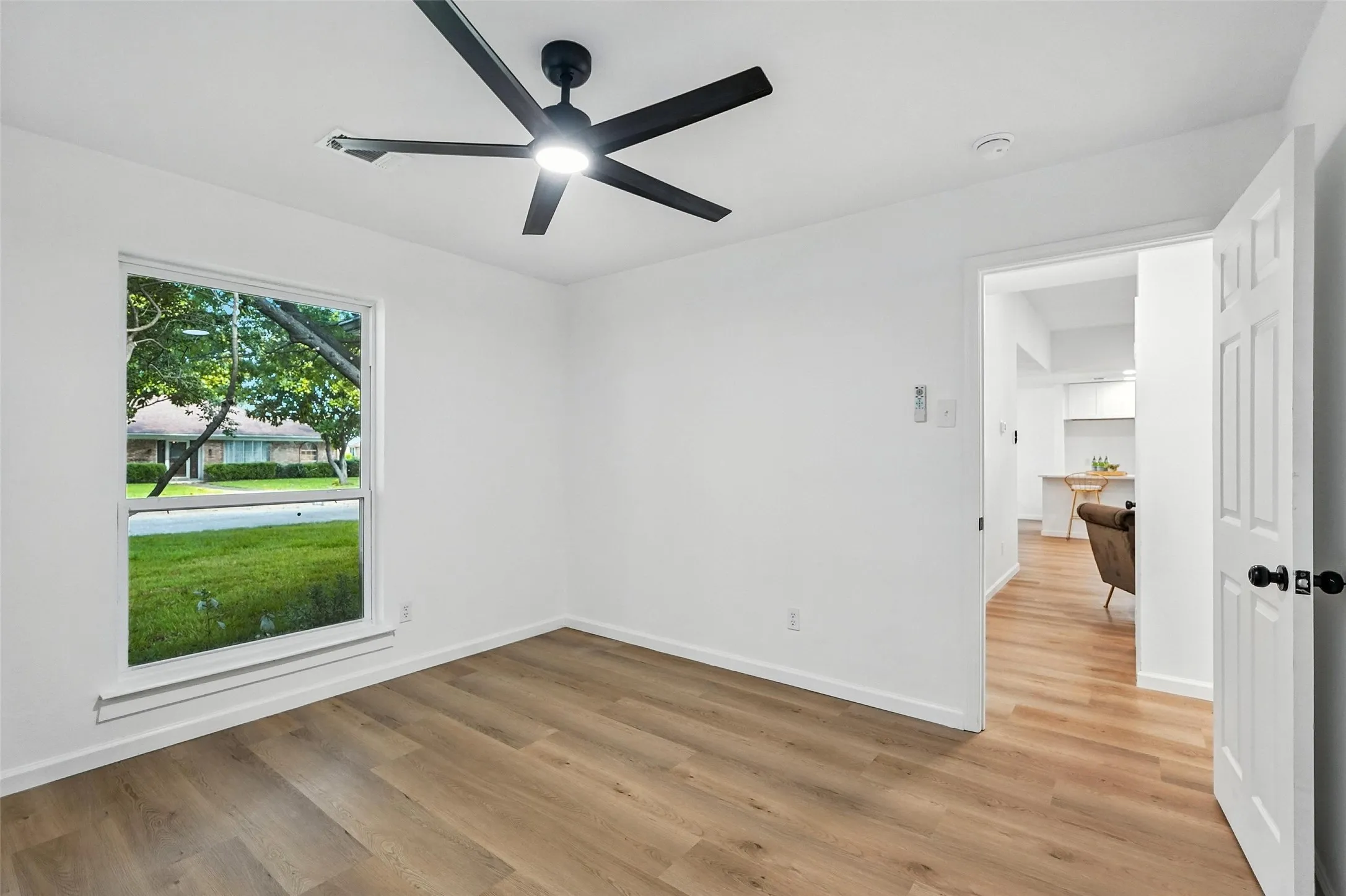 Spare room featuring light wood finished floors and a ceiling fan