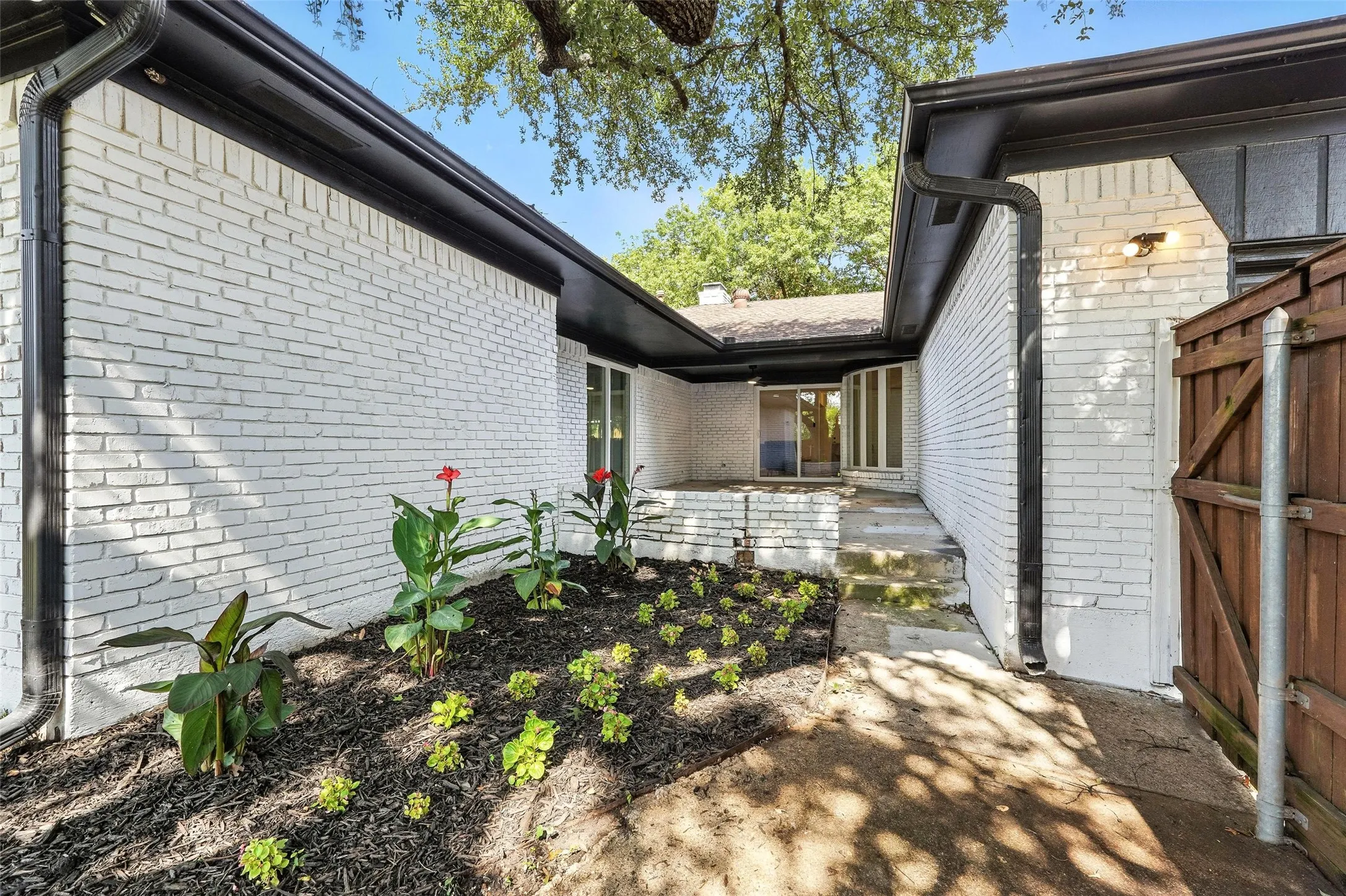 View of property exterior with brick siding