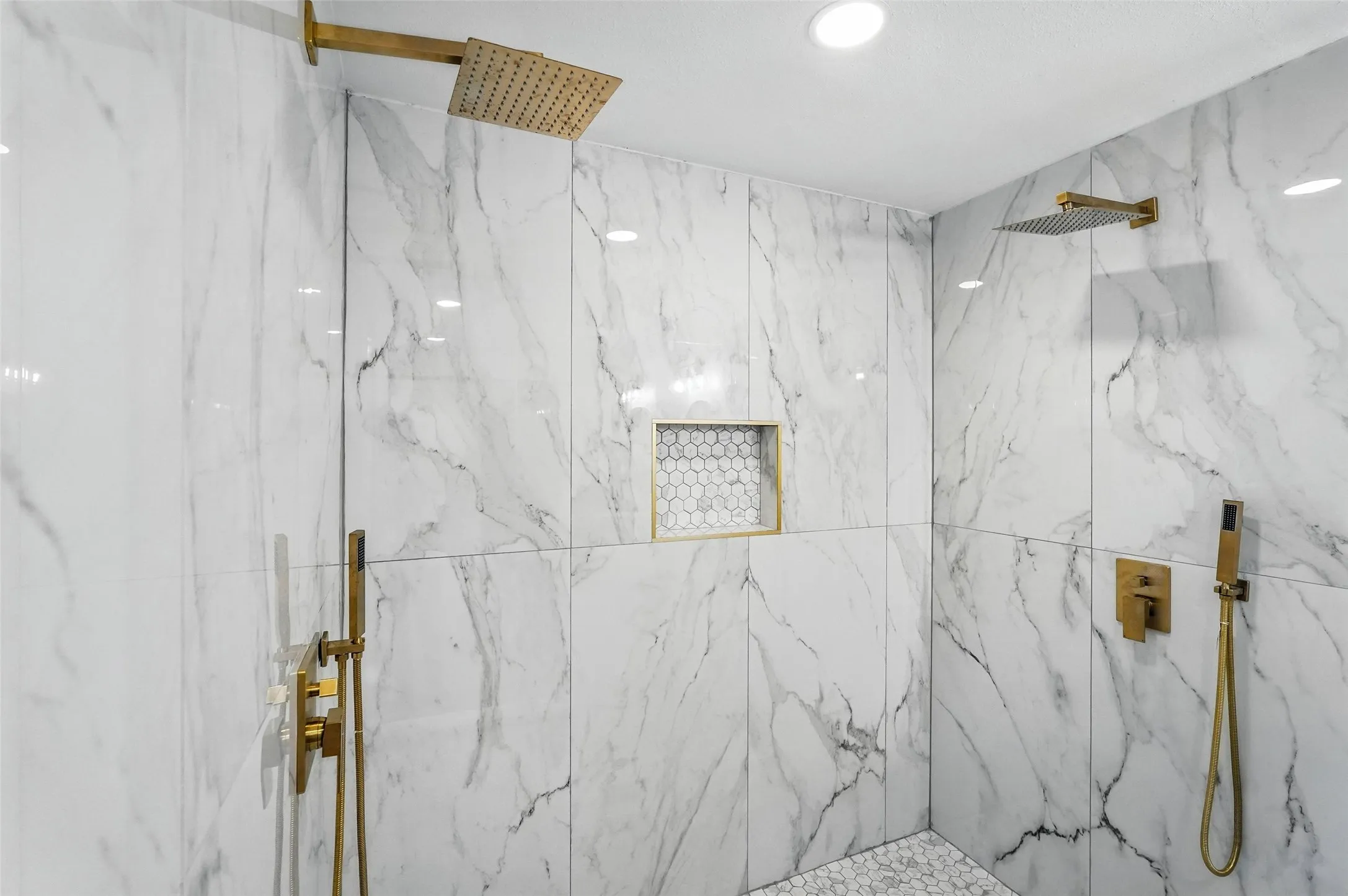 Bathroom with a marble finish shower