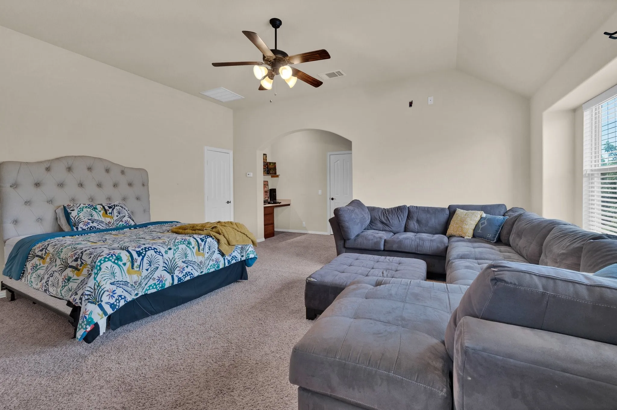 Versatile upstairs space with a bathroom, built-in desk area, and attic access