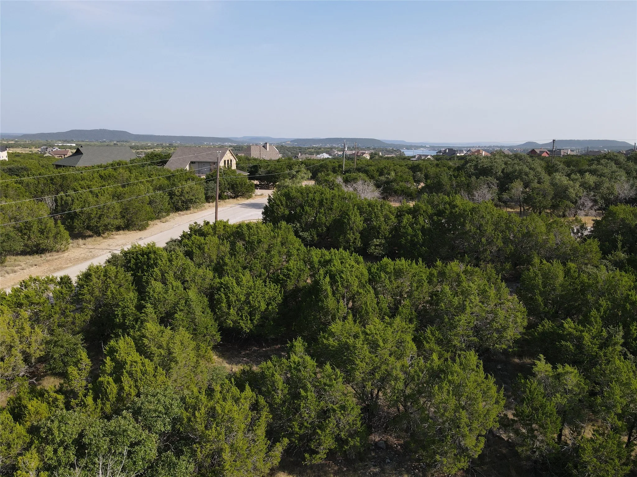 Expansive undeveloped lot featuring mature trees and partial clearing, providing a natural setting