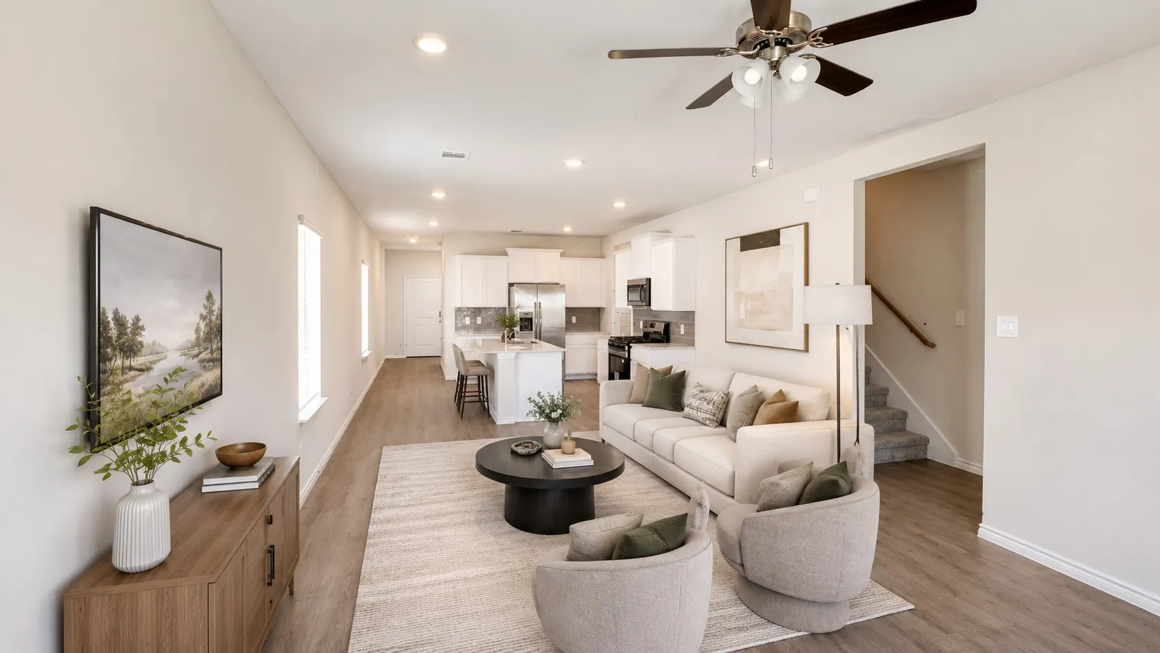 Open-concept living space featuring wood-finish flooring, recessed lighting, and a ceiling fan with light kit
