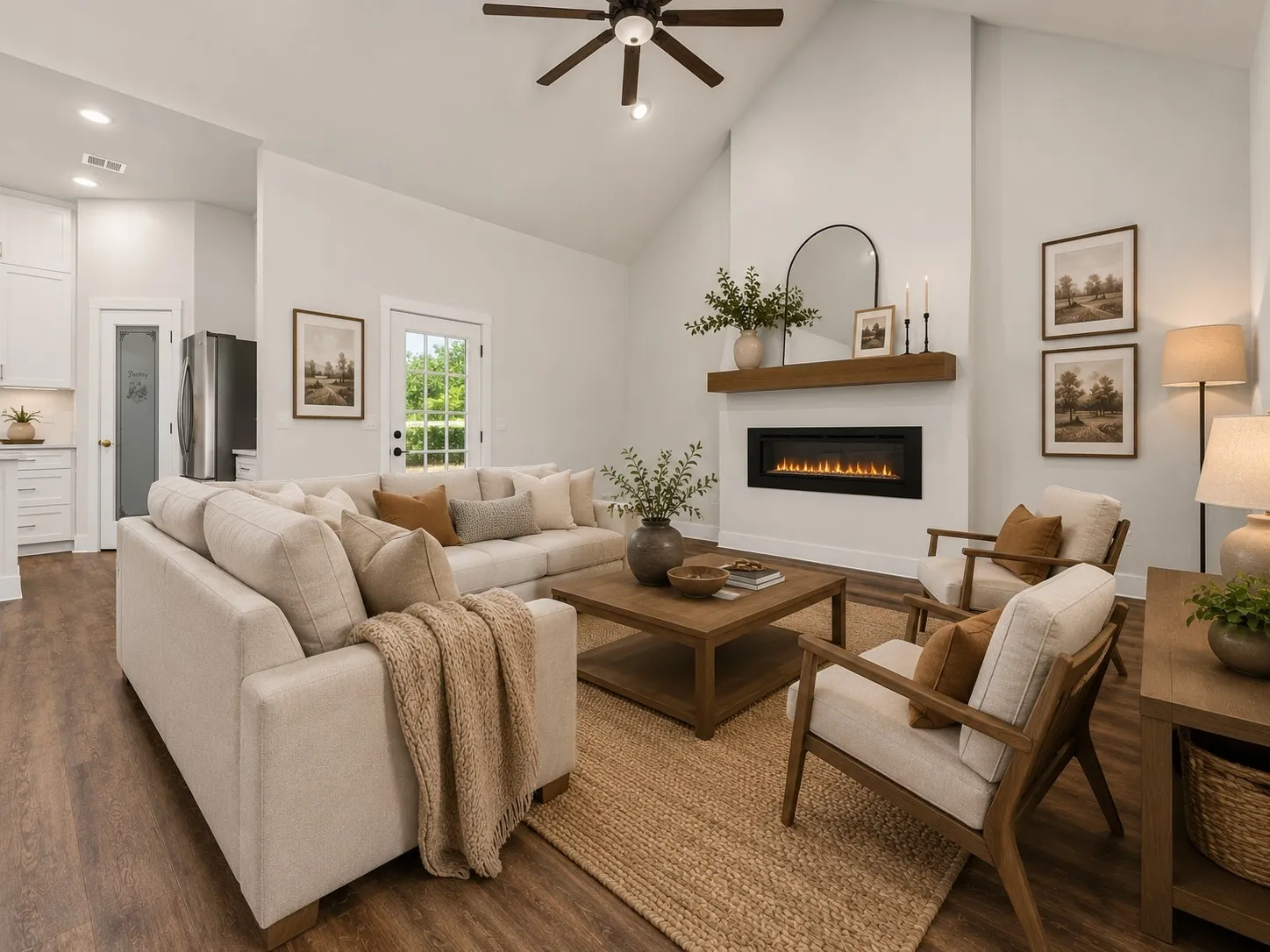 Vaulted ceiling living area featuring wood-finish flooring, a contemporary linear fireplace with a wood mantel, a ceiling fan, and a glass-paneled door
