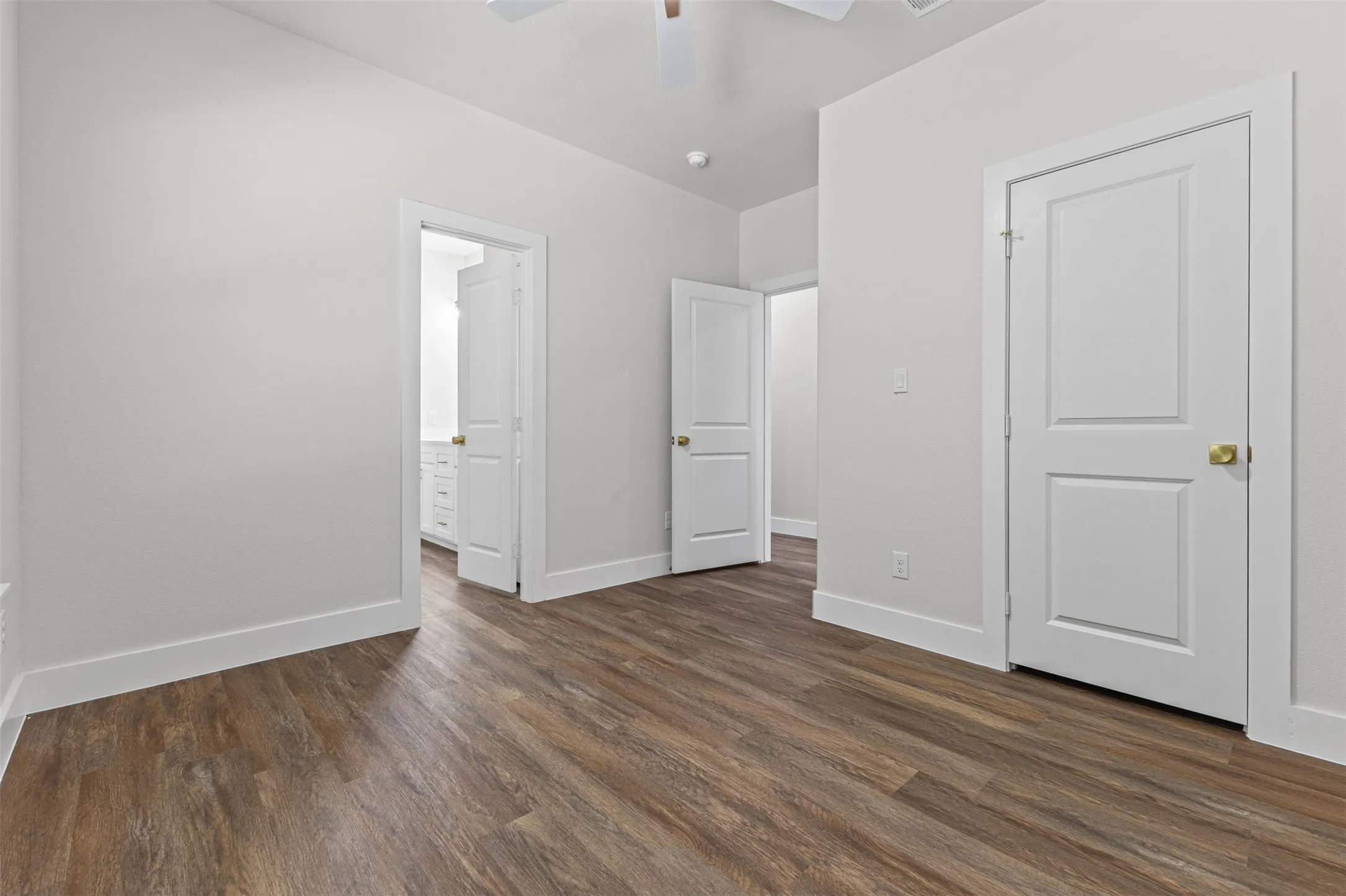 Spacious interior featuring wood-finish flooring, light-toned walls, and white trim