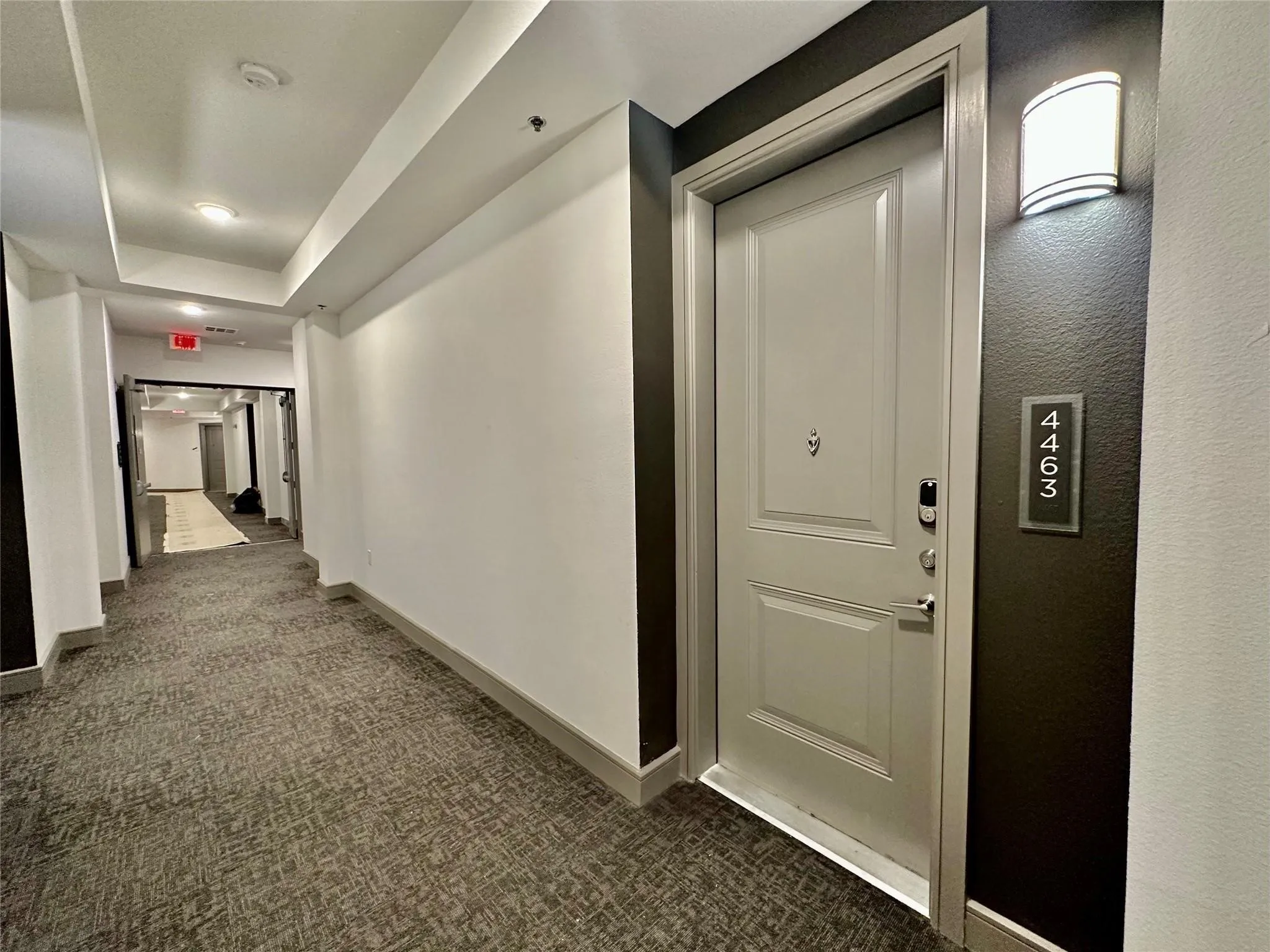 Entry door with contemporary hardware and wall sconce illumination