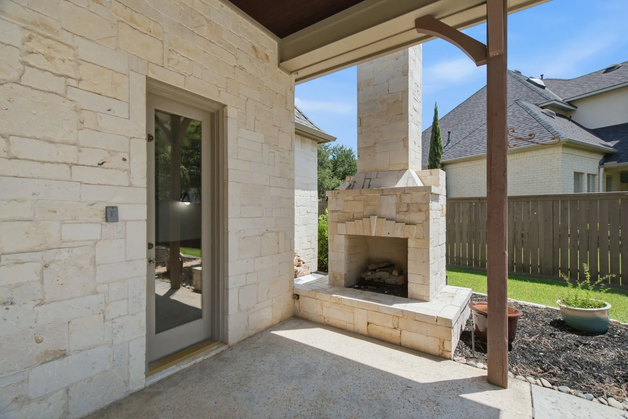 Full-light door, tile flooring, white cabinetry, integrated sink, and brown countertops