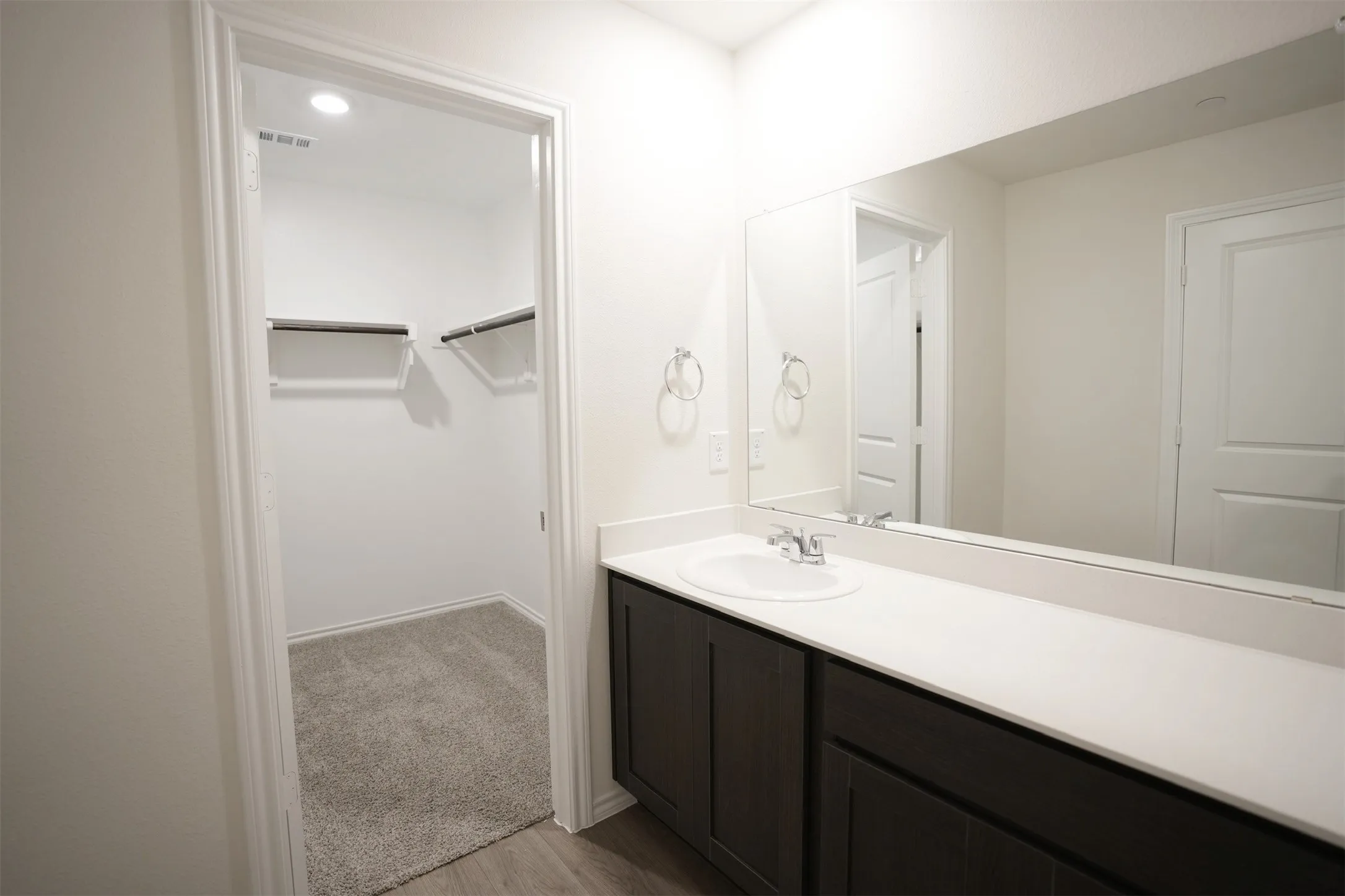 Spacious bathroom vanity featuring a single undermount sink and a broad countertop