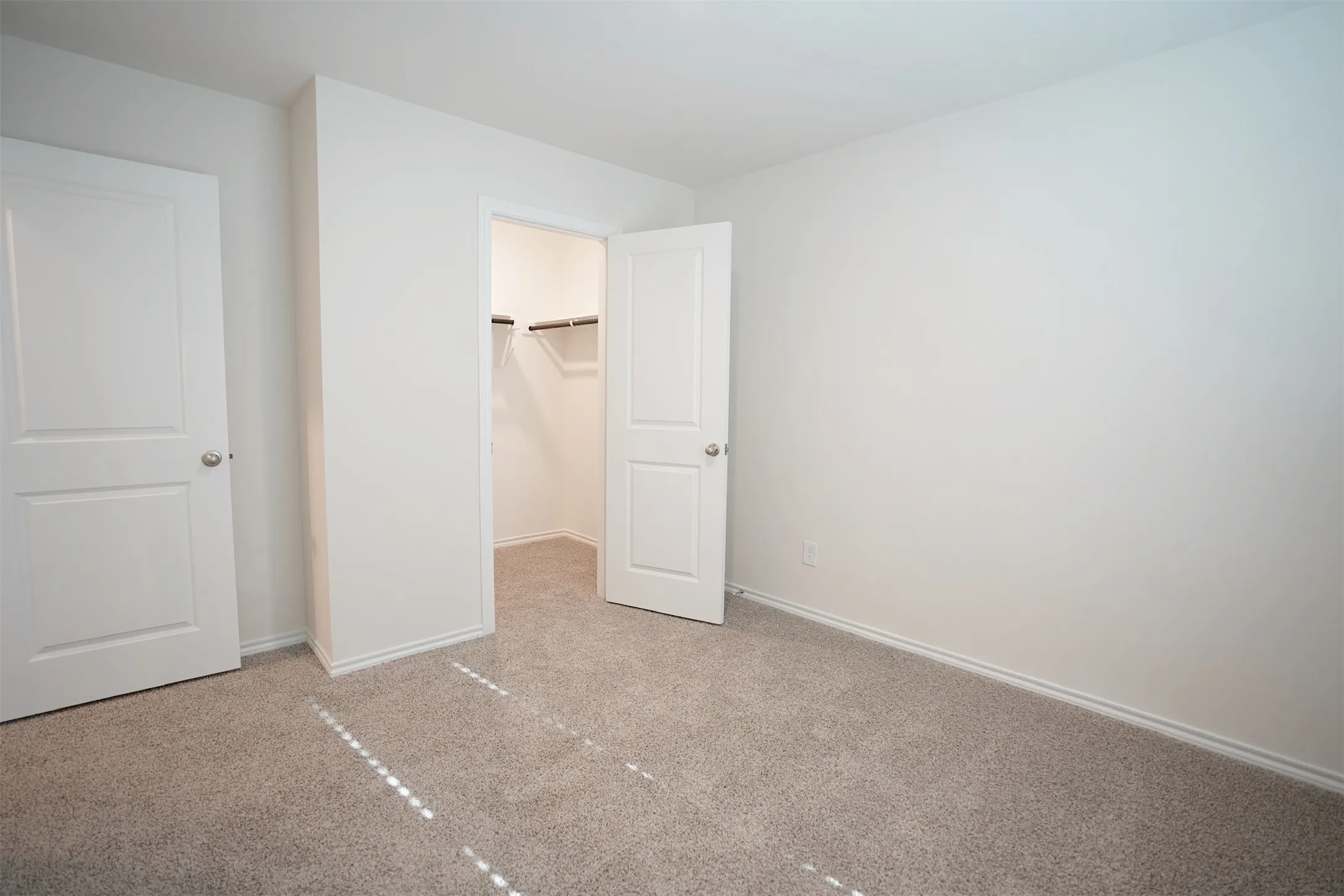Neutral wall paint and plush carpeting establish a versatile foundation for personalization