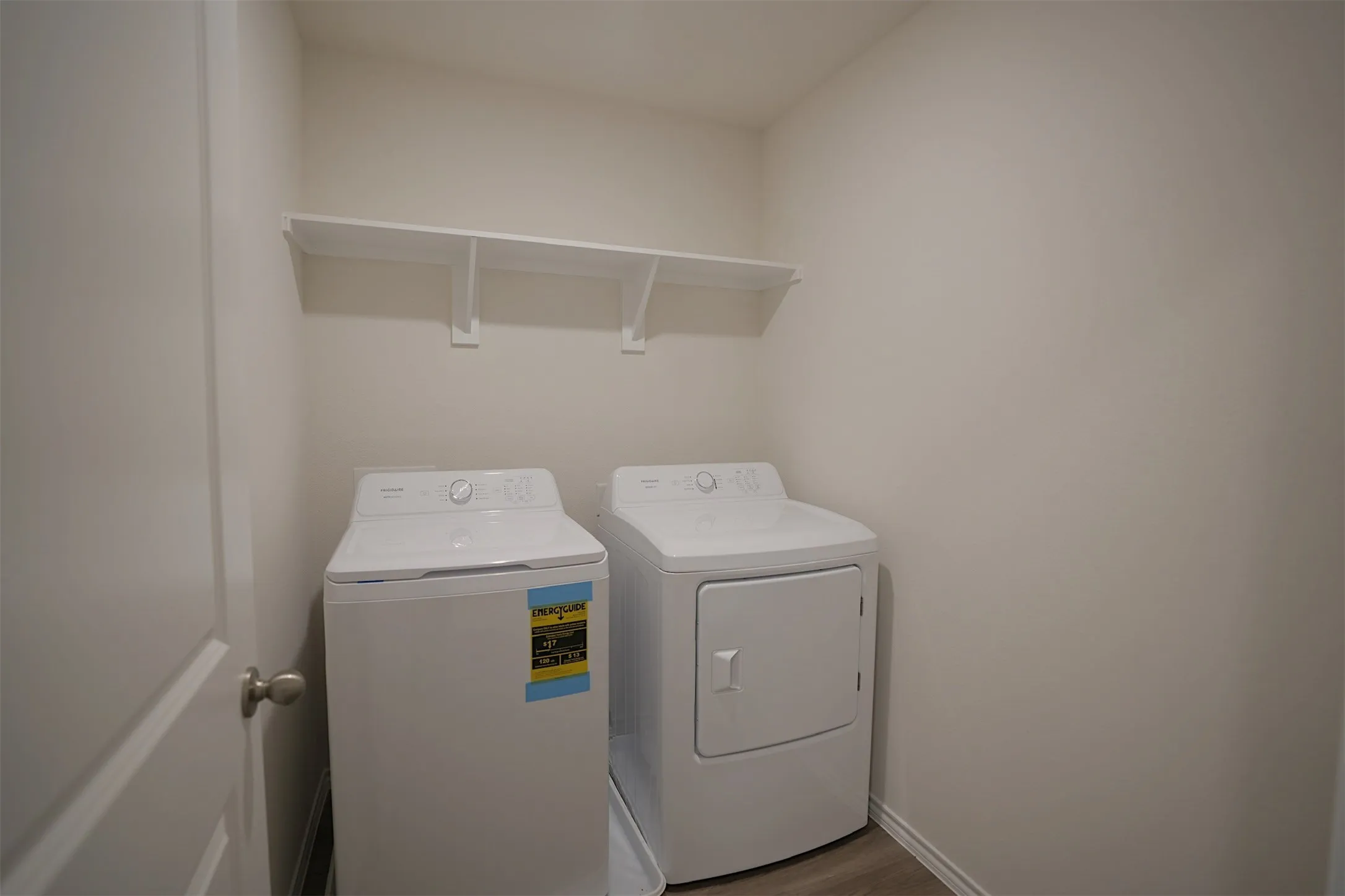 Dedicated laundry area featuring a white top-load washer and front-load dryer