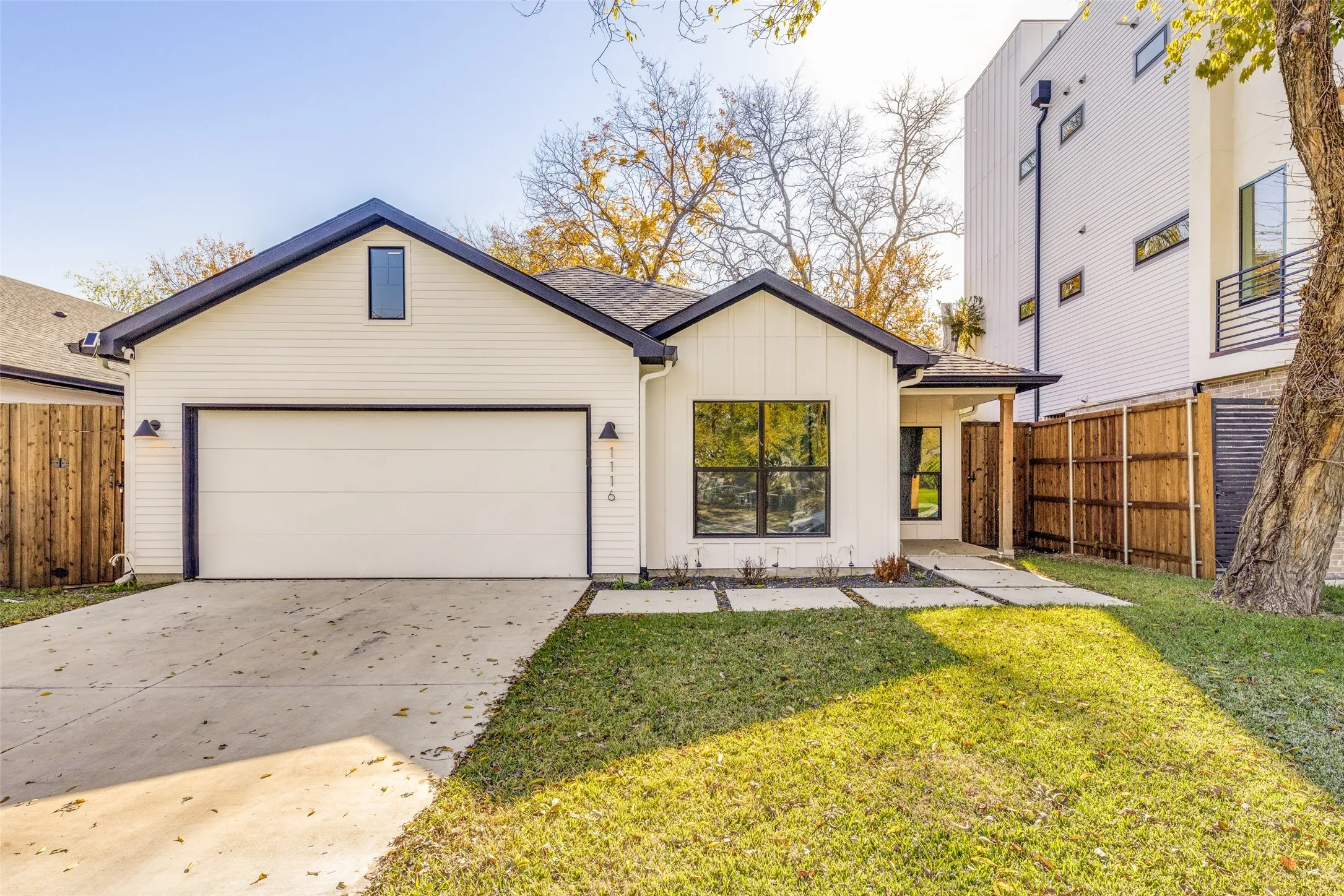 Modern white siding exterior with a dark trim roofline