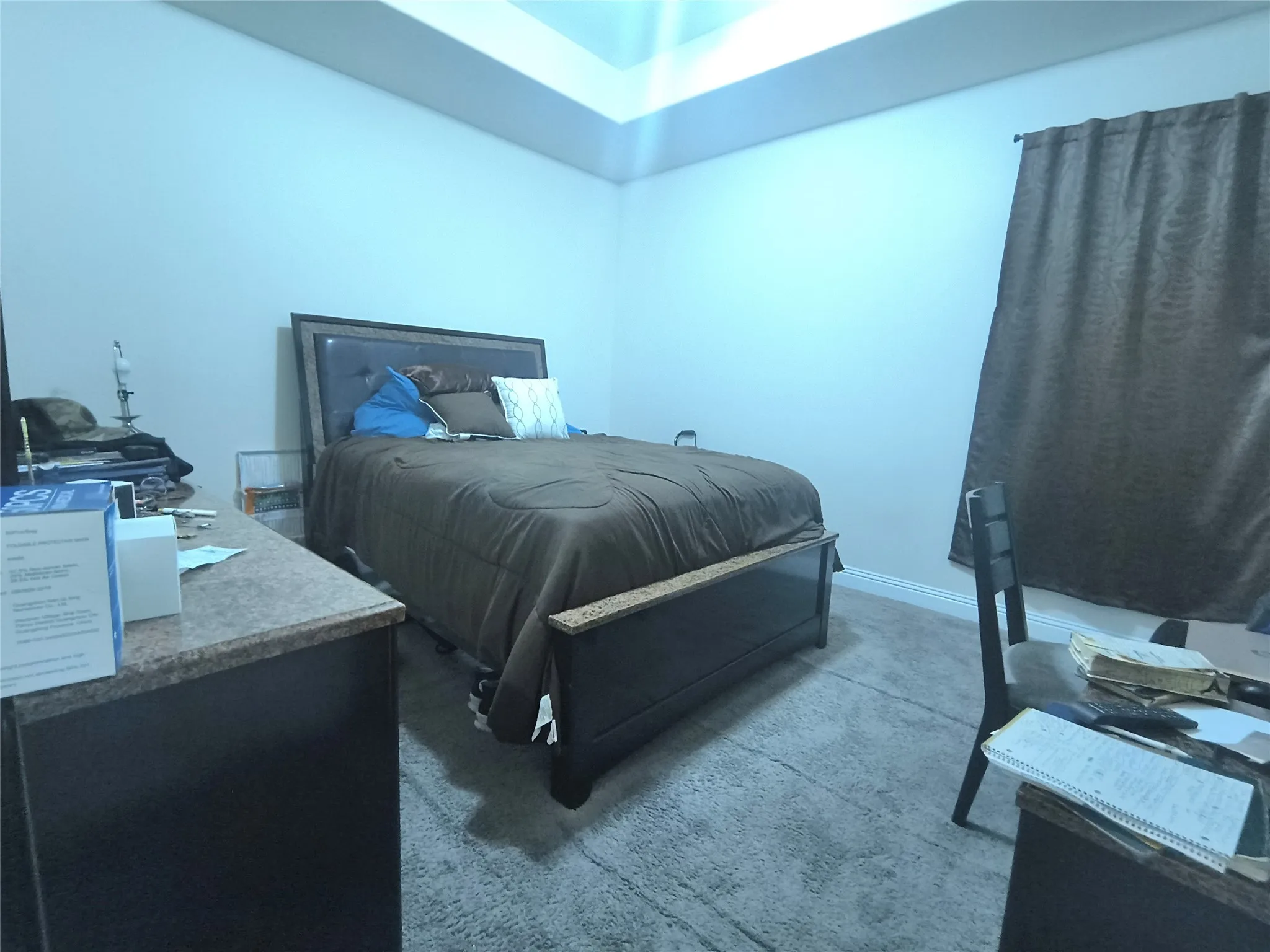 Carpeted room featuring a tray ceiling with recessed lighting