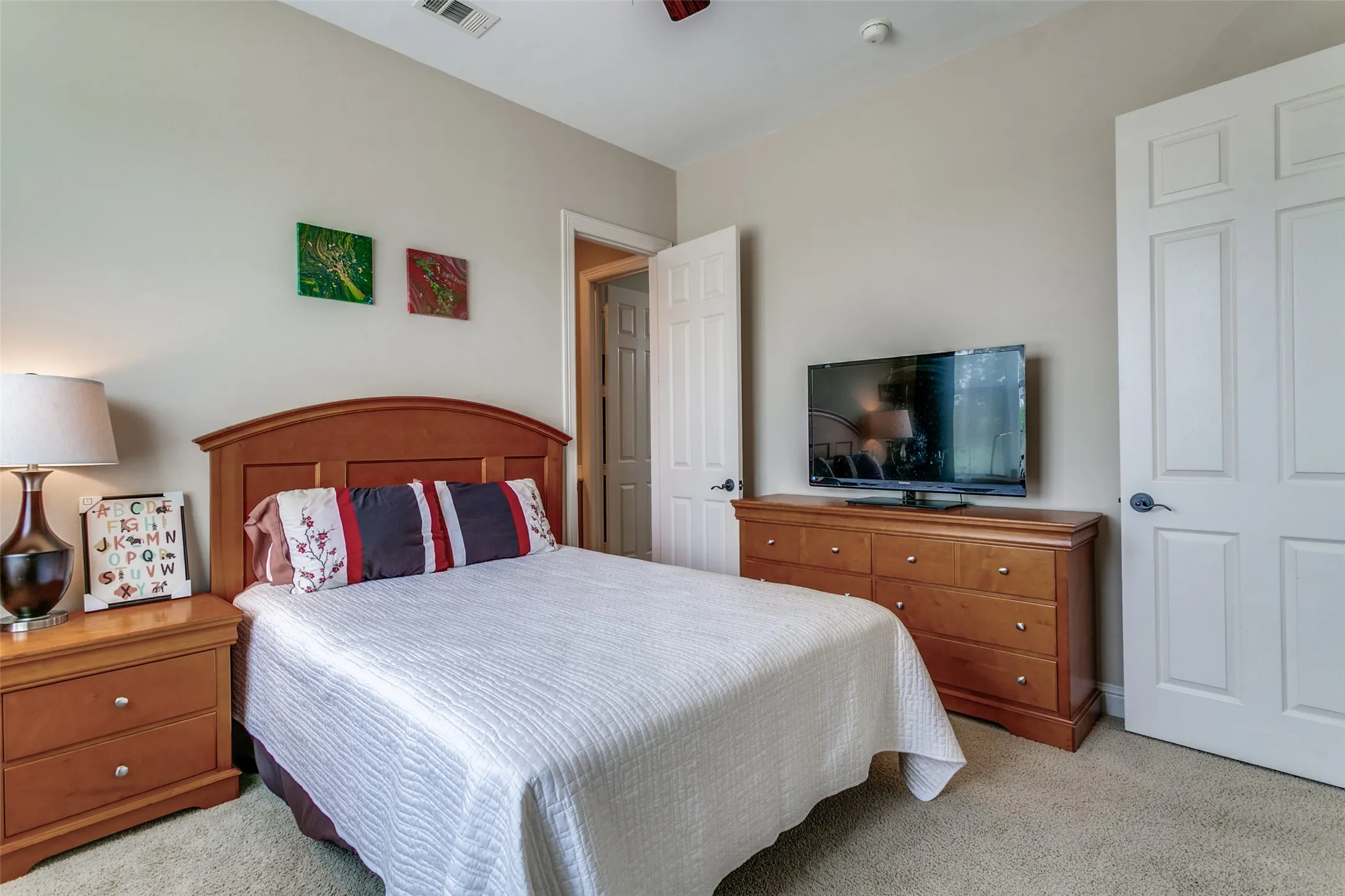 Spacious secondary bedroom with natural light and convenient access to the shared bathroom.