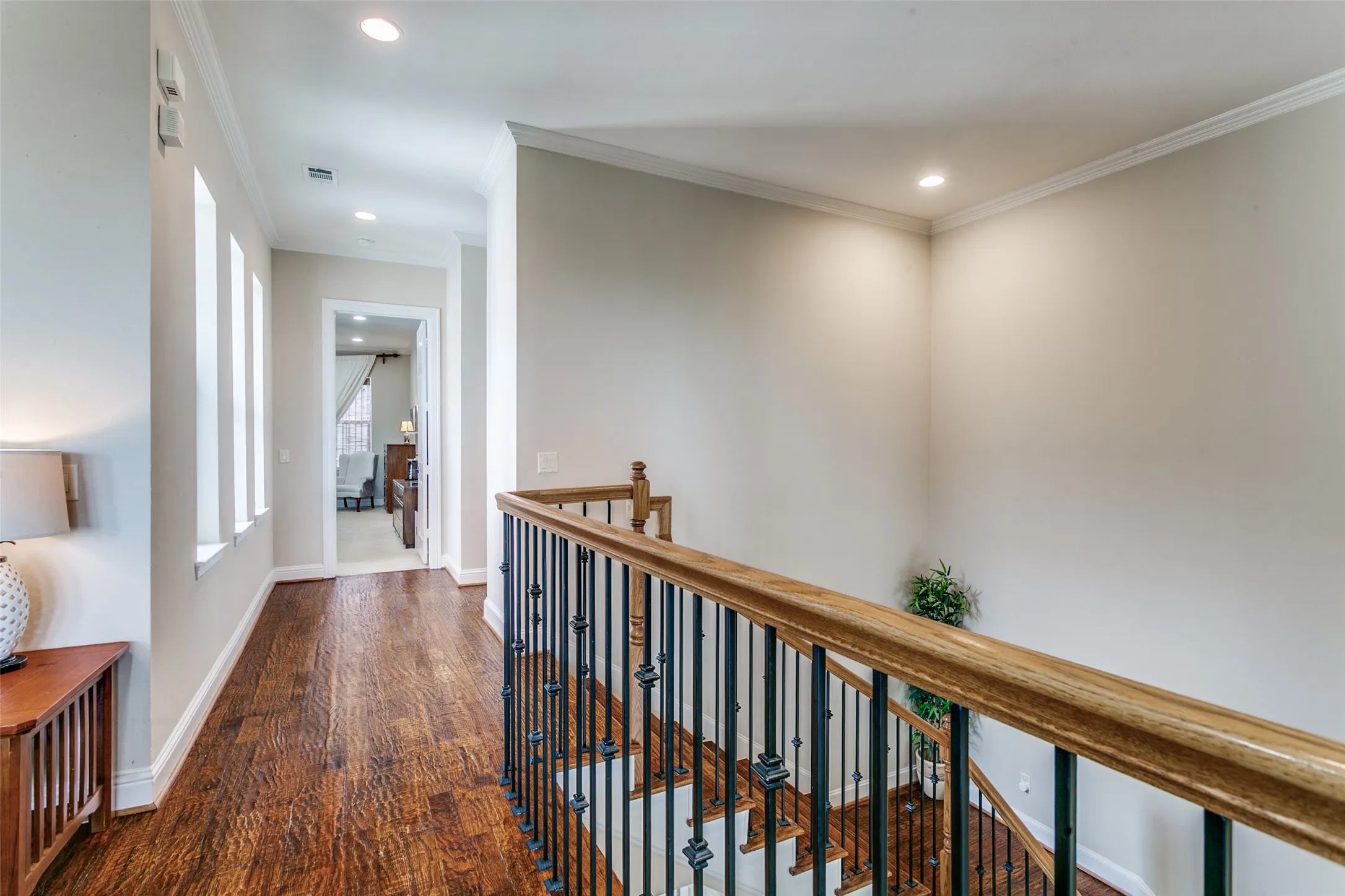 Spacious entryway featuring tile flooring and a beautifully crafted hardwood staircase.