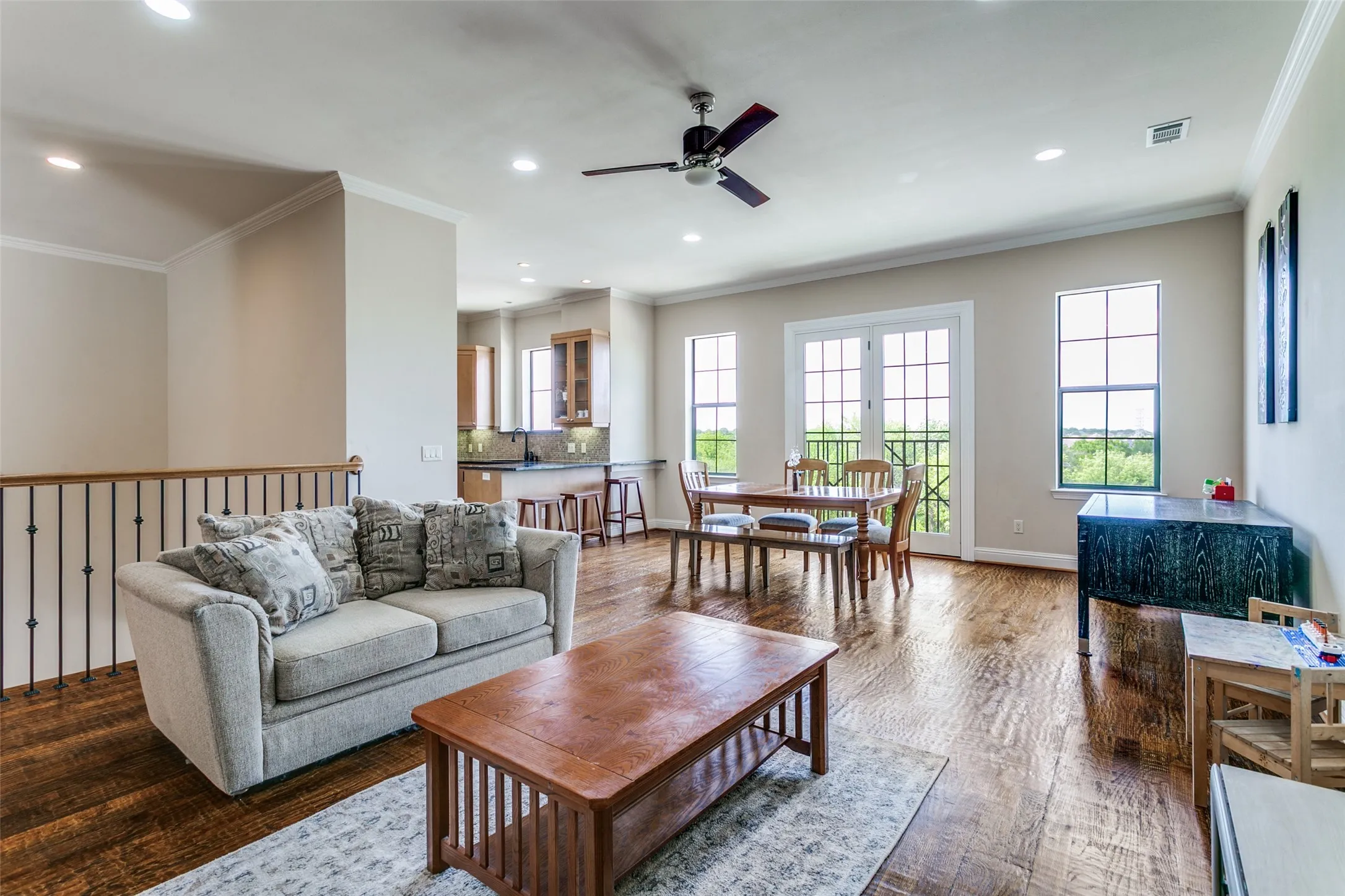 Generous living area with a bright, airy feel and warm wood flooring that adds character to the space.