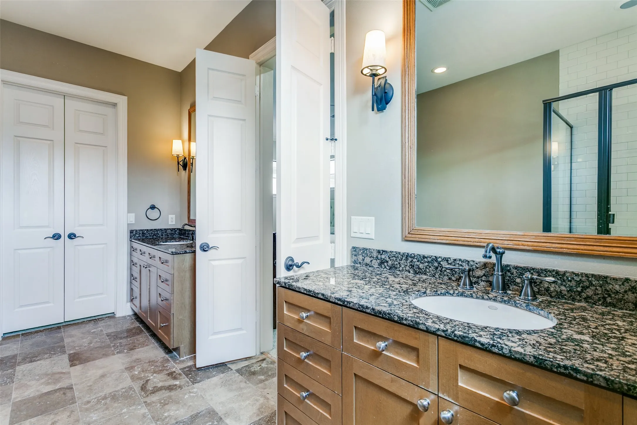 The primary bathroom features dual vanities, generous counter space, and a large walk-in closet.