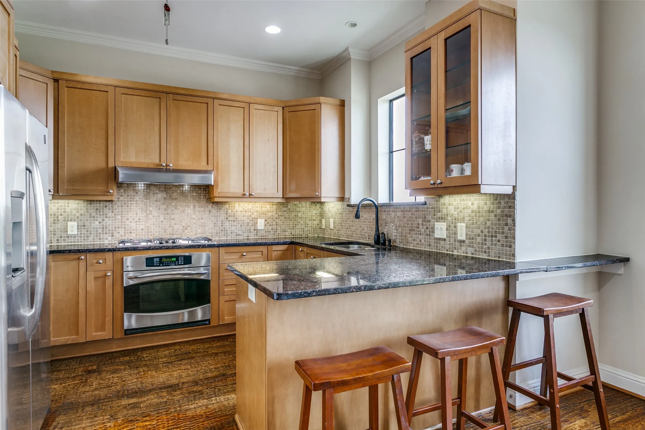 Open kitchen featuring a sink with a window view, creating a bright and open feel.