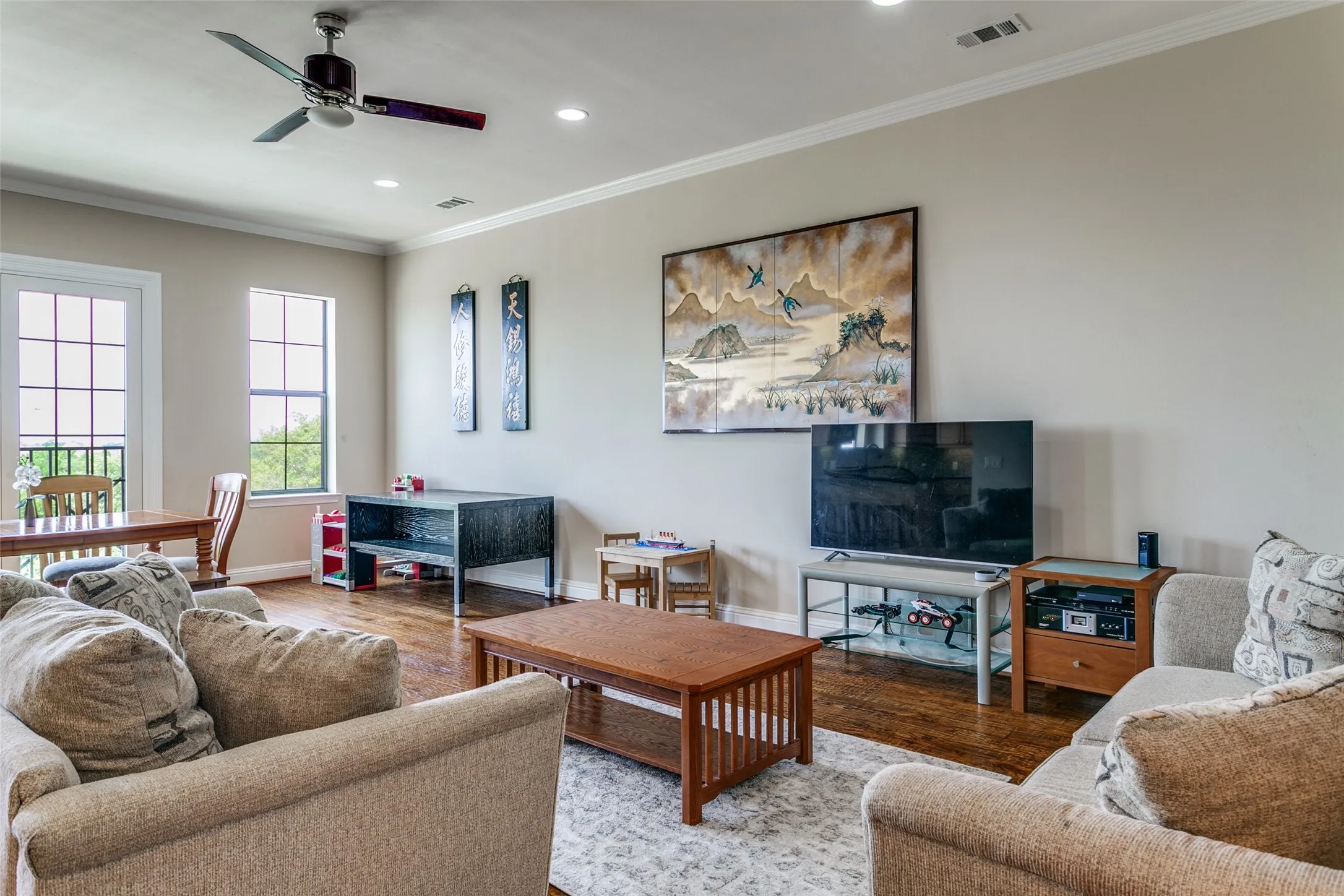 Spacious living room with an open layout and views of the surrounding green space.