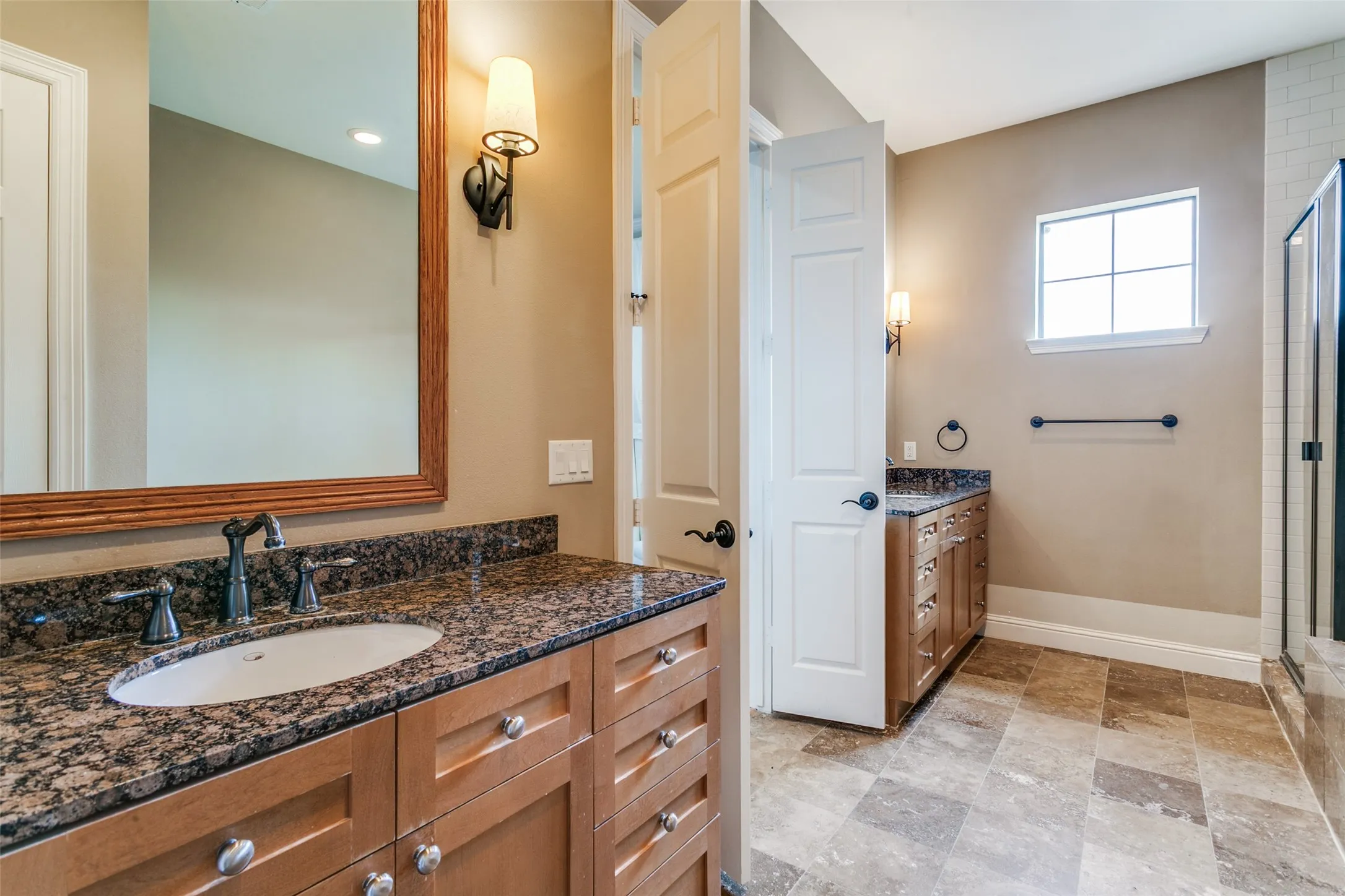 Spacious and thoughtfully designed, the primary bathroom offers a comfortable blend of style and functionality.
