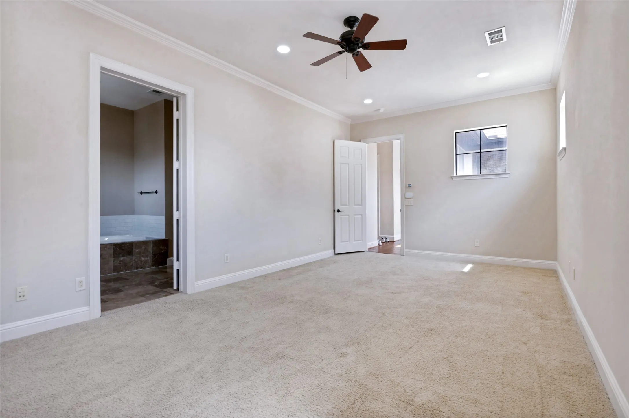 Oversized primary bedroom with plenty of room for a sitting area, additional furnishings, or a private workspace.